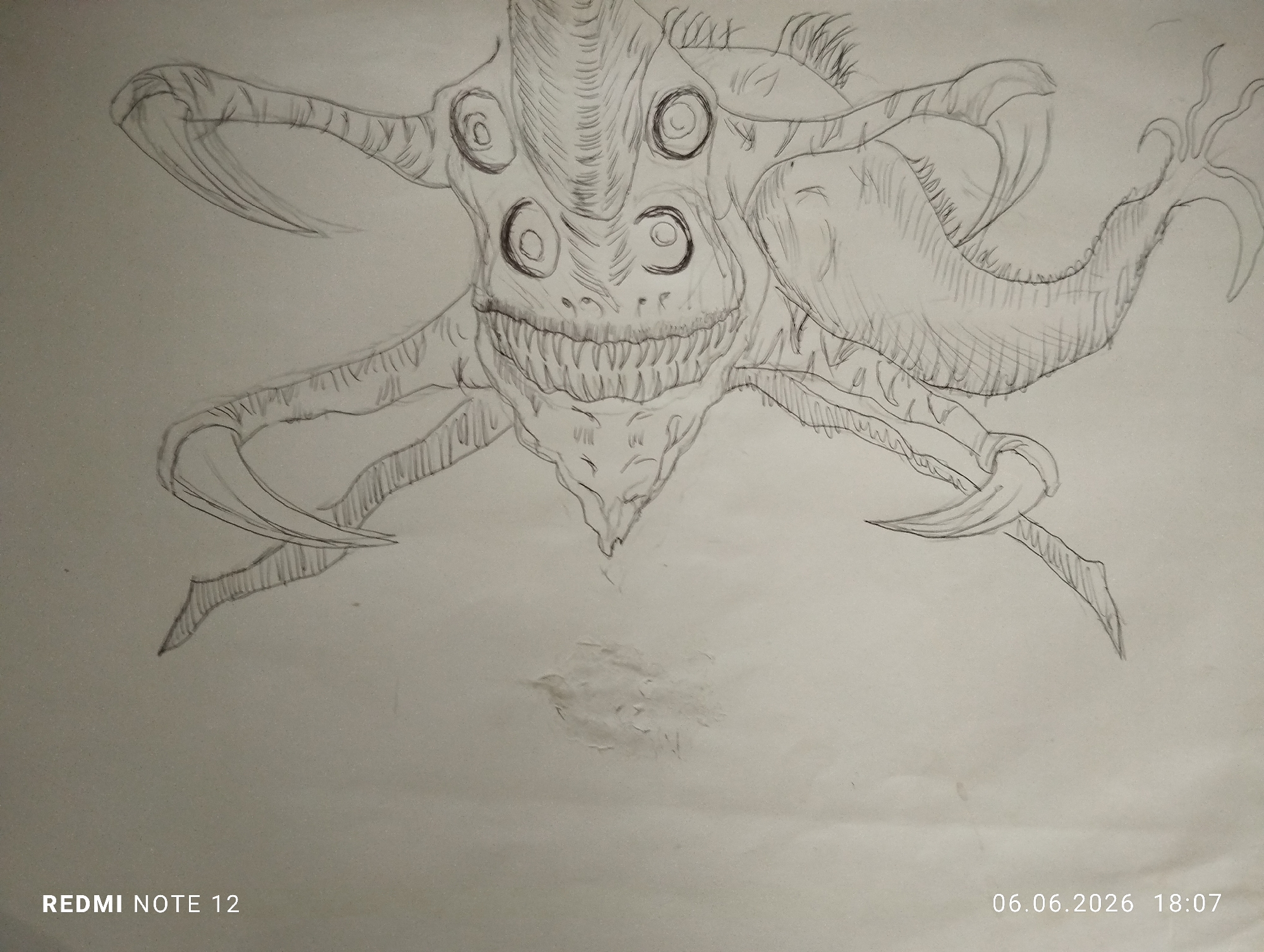The image is a photograph of a monochrome pencil drawing on a light-colored paper, captured in the city of Burgas, Bulgaria. The drawing depicts a monstrous, multi-limbed creature centered on the page. The creature's head is characterized by a wide, serrated mouth displaying multiple rows of sharp, conical teeth. Above the mouth, four large, dark, circular eyes are symmetrically arranged in two pairs, conveying an intense gaze. Spiky, fibrous textures resembling hair or quills protrude from the creature's cranium and lateral head regions. Its torso is robust and vertically striated, tapering to a pointed abdomen. Multiple limbs extend from the creature's body: two prominent arms on the left terminate in large, curved, blade-like claws. On the right side, an upper, broader limb resembles a fin or wing, while a lower limb also ends in a large claw. A distinct, elongated appendage resembling a tail or tendrilled limb extends from the far right, terminating in multiple splayed digits. The drawing is executed with varying pencil pressures, creating textural details and depth. The paper exhibits minor creasing and a subtle area of erasure or surface abrasion centrally below the creature. Digital watermarks indicate the photograph was taken by a 'REDMI NOTE 12' device, timestamped '06.06.2026 18:07'.