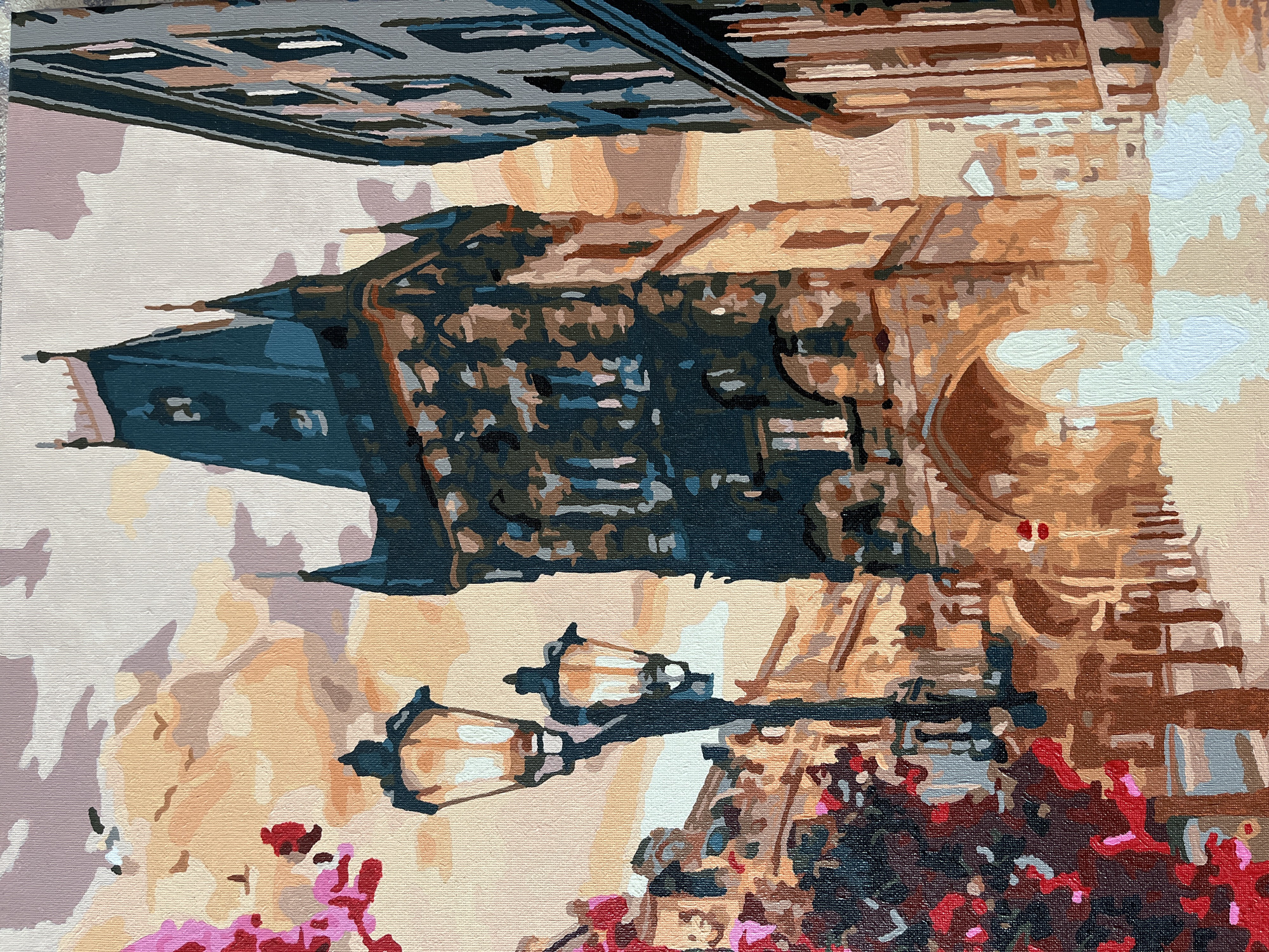 This is a close-up, vertical painting of an urban scene, likely a street at dusk or dawn given the warm, soft lighting. The subject is architectural, focusing on the details of a building's facade and elements of its surroundings. A dark, imposing structure, possibly a tower or a section of a larger building, dominates the left side of the frame. It is rendered in deep teal and black, with sharp, angular lines suggesting windows or decorative elements.
To the right of this structure, the building's facade is depicted with warm, earthy tones of brown, tan, and beige, creating a textured, stone-like appearance. Horizontal lines and subtle shading suggest architectural details such as balconies, ledges, or window frames.
In the foreground, a pair of ornate street lamps are visible, casting a gentle, warm glow. They are made of dark metal with glass enclosures that are painted in shades of yellow and white, suggesting illuminated bulbs. Below and to the right of the lamps, a mass of vibrant flowers in shades of red, pink, and darker purples creates a stark contrast to the architectural elements. The flowers appear lush and in full bloom, adding a touch of natural beauty to the urban setting.
The overall impression is one of a quiet, atmospheric moment in a European city, perhaps a charming side street. The painting style is somewhat abstract, with distinct brushstrokes and a limited, yet effective, color palette. There is no visible text in the image.