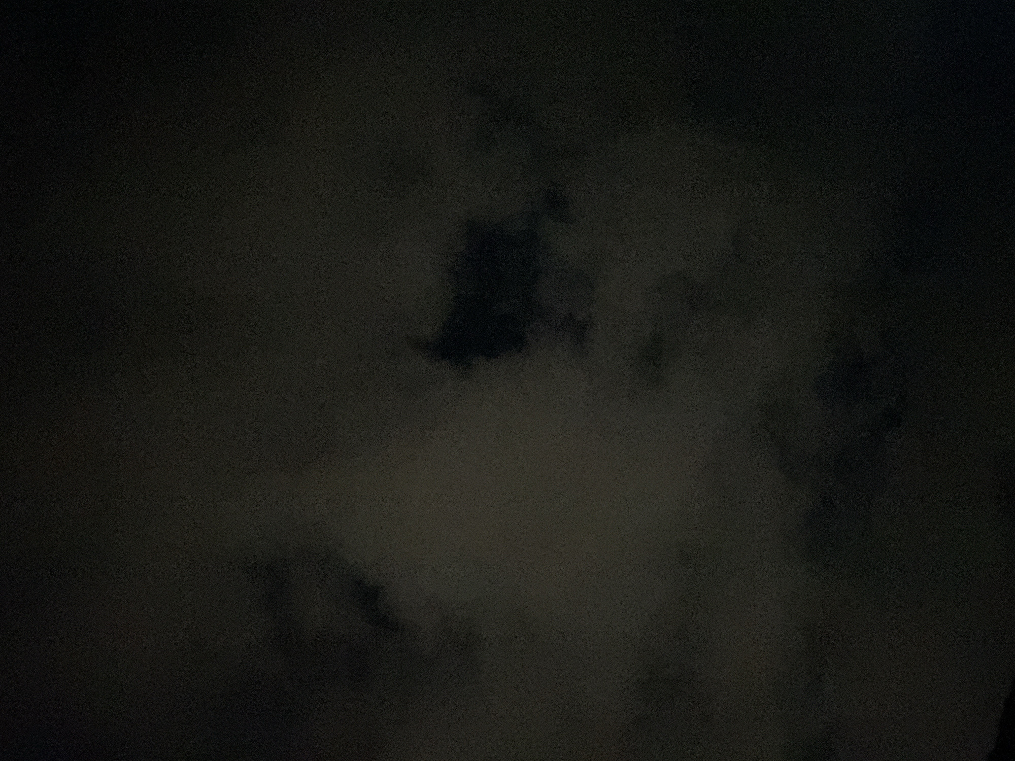 The image shows a dark, cloudy night sky. Details of cloud formations are vaguely visible against the slightly less dark background. There is no information available in the image to identify its location in Burgas, Bulgaria, or any specific people, subjects, objects, actions, or interactions within the scene.