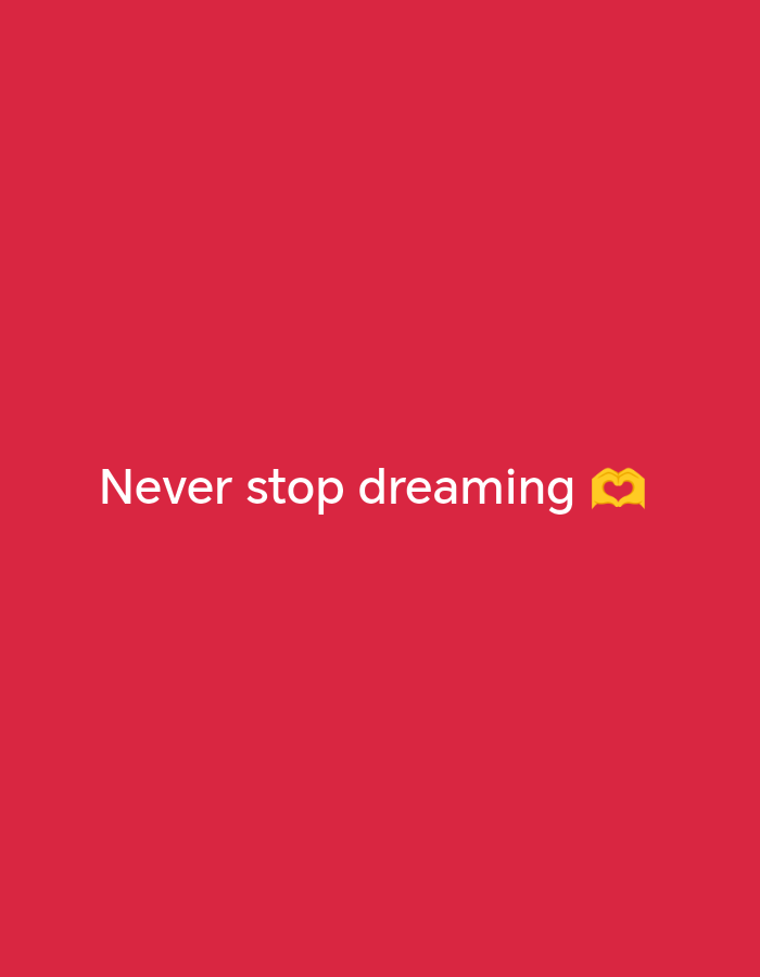 The image is a plain red background with white text that reads "Never stop dreaming". To the right of the text is a yellow emoji of two hands forming a heart shape. The image does not contain any information or context related to the city of Stavropol, Russia.