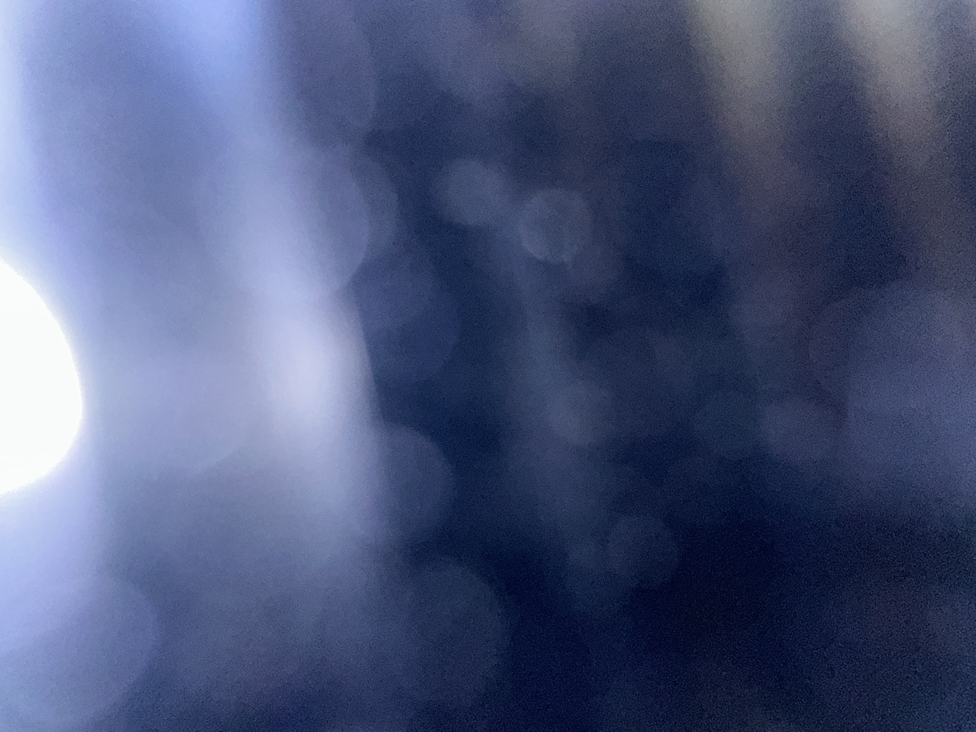 This media file is an abstract, out-of-focus image with a dark blue and light blue color palette. The image appears to be a close-up shot, possibly of a textured surface with light sources causing bokeh effects. There are no discernible subjects such as people, objects, or a clear scene. The activity or event taking place is not identifiable. Notable details like time of day, weather, or location cues are absent due to the abstract nature of the image. No emotions are conveyed, and there is no visible text. The provided location context of Belgrade, Serbia, does not offer any visual clues within the image itself. The overall impression is that of a digitally manipulated or abstract photographic composition, likely focusing on light and color rather than representational content.