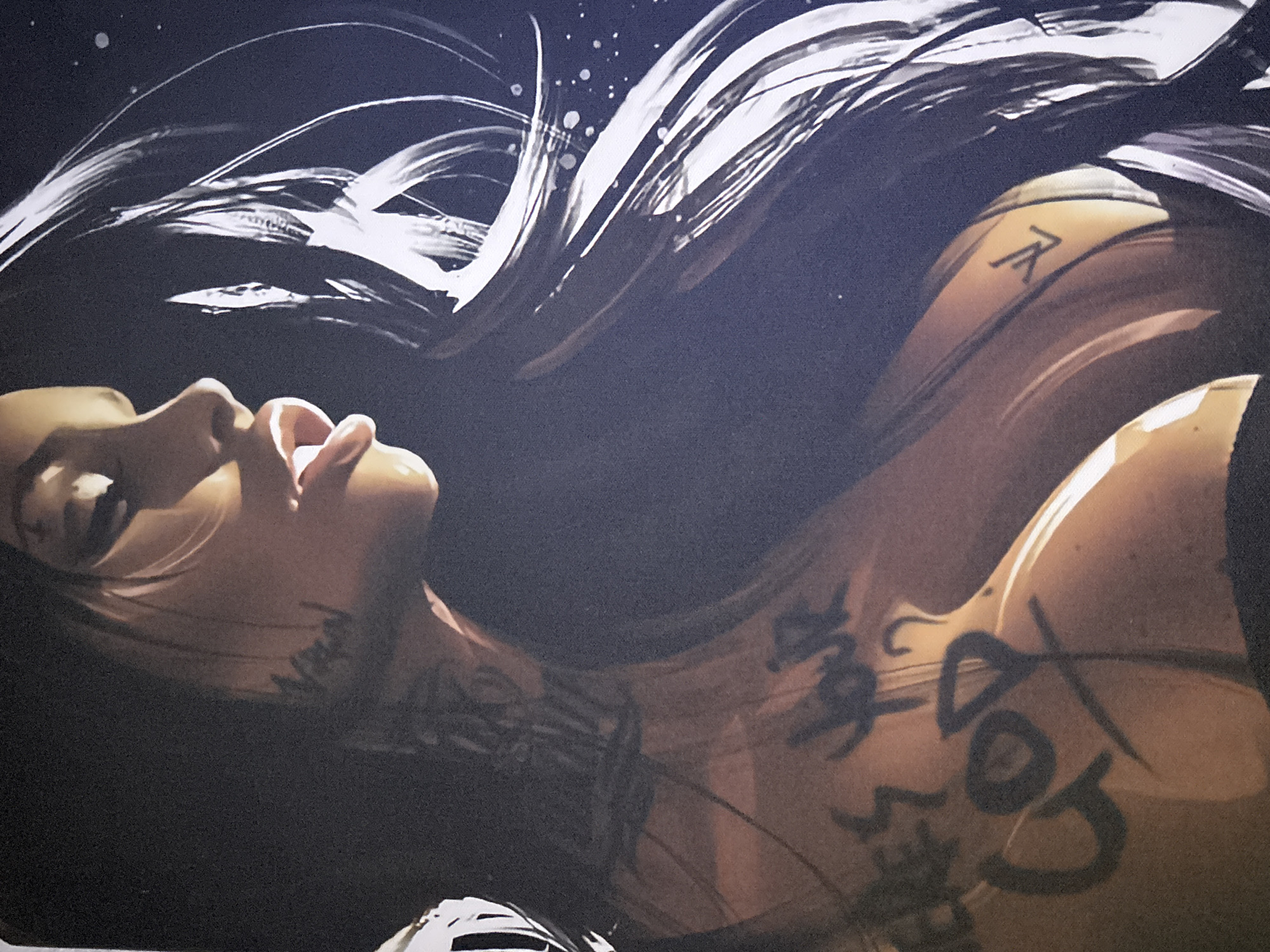 The image is a close-up of a stylized illustration of a woman with long dark hair. She has visible tattoos on her neck and chest. The tattoos on her chest read "heres your god" and "god" with a cross. A Louis Vuitton logo is also visible on her chest. The background is dark and abstract, with some white speckles. The image does not contain any information about the city of Gurkovo, Bulgaria, or any real-world location.