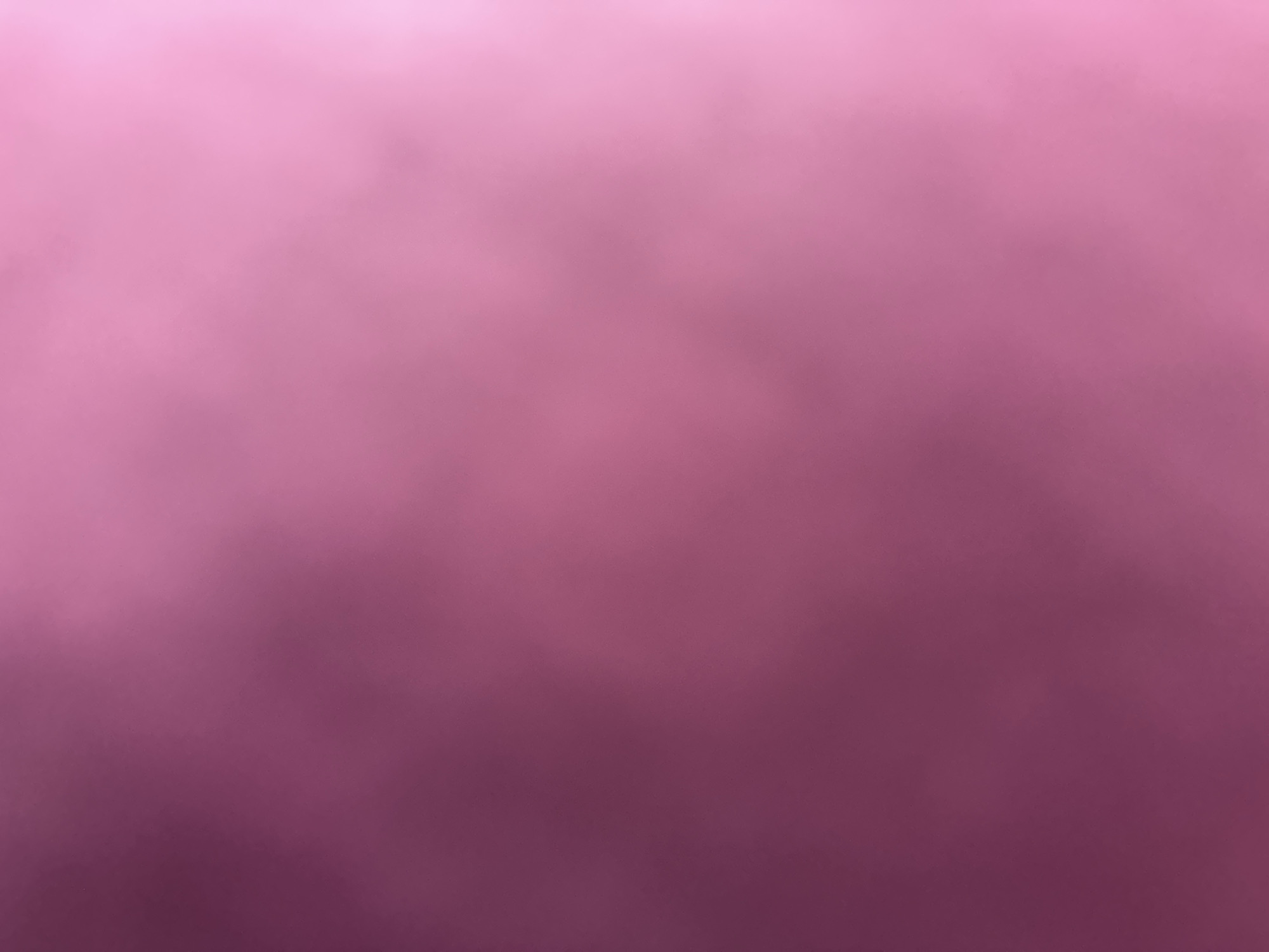 The image is a close-up, abstract shot of a pink gradient. The color transitions from a lighter, almost pastel pink at the top to a deeper, richer magenta at the bottom. There are no discernible subjects, objects, scene, or setting. No activity or event is taking place. The image lacks any notable details such as time of day, weather, location cues, or emotions. There is no visible text. The file appears to be a background or a texture rather than a photograph of a specific subject matter.