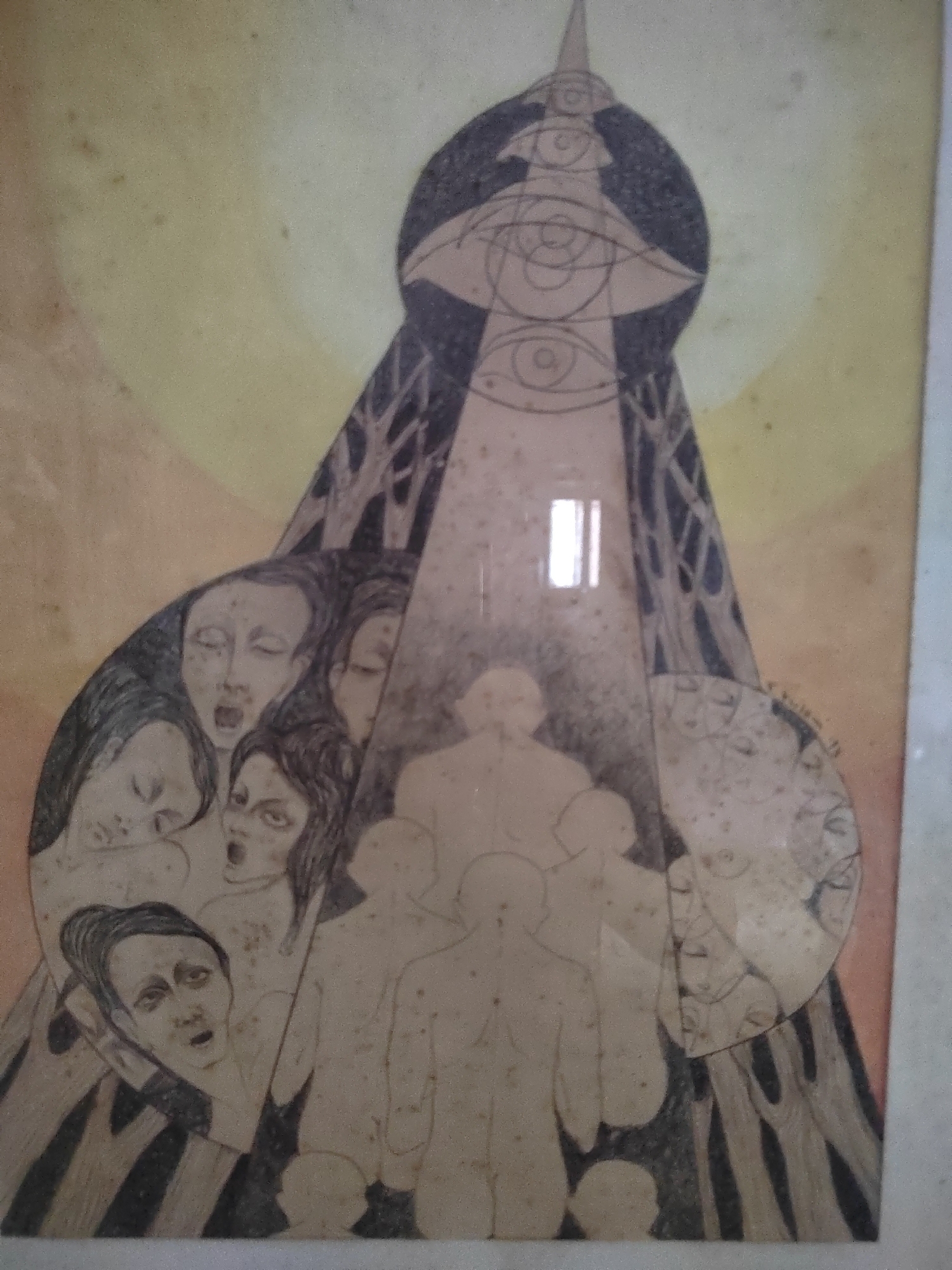 The image depicts a surreal and unsettling artwork, possibly a painting or drawing, with a muted color palette dominated by yellows and grays. The central element is a conical structure resembling a stylized tower or headdress, adorned with multiple eye motifs. A beam of light emanates from the top of this structure, illuminating a cluster of human figures.
The figures are rendered in an ethereal, almost ghost-like manner, with indistinct features. Some appear to be screaming or expressing distress, their mouths open in silent cries. Others are depicted with closed eyes, conveying a sense of suffering or resignation. The arrangement of these figures suggests a group undergoing some sort of collective experience, possibly under duress or within a dreamlike state.
The background features abstract representations of trees, adding to the overall dreamlike and possibly nightmarish quality of the artwork. There are also circular elements in the composition, one of which contains a faint depiction of faces.
The artwork is framed by a light-colored border, and the surface exhibits signs of age, with a speckled texture and potential staining. There is no discernible indication of this artwork being located in Porto Recanati, Italy; the description focuses solely on the visual content of the image.