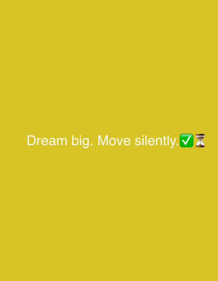 The image is a plain, solid yellow background with white text that reads "Dream big. Move silently." followed by two emojis: a green checkmark and an hourglass. The text and emojis are centered horizontally and located in the bottom third of the image. There are no people, buildings, or any other objects or environmental features visible. It is not possible to determine the location in Sofia, Bulgaria, from the provided image.