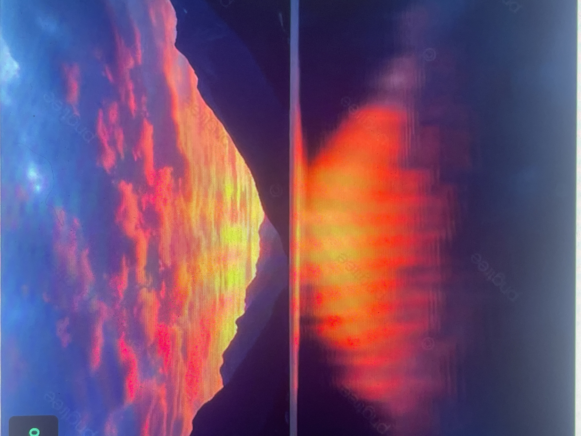 The image displays a panoramic natural landscape scene attributed to the city of Zelenyi Hai, Ukraine, depicting a vibrant sunset or sunrise over a large body of water and a distant mountain range. The sky, occupying the upper portion, features a dramatic gradient of colors: intense yellow and orange hues are concentrated at the horizon, transitioning upwards into vivid reds and bright pinks within scattered clouds, and finally fading into deep purple and blue towards the top of the frame. A dark, silhouetted mountain range, rendered in deep blue and purple tones, spans the mid-ground, forming a clear boundary between the sky and the water. The calm surface of the lake, which fills the lower half of the image, perfectly mirrors the brilliant colors of the sky, with fiery reds, oranges, and yellows strongly reflected in the foreground. No human figures, animals, structures, or any signs of human activity are visible within the scene. Faint "pngtree" watermarks are subtly overlaid across various sections of the image. A small, dark green rectangular overlay containing the white numeral "0" is present in the upper left corner. The entire image exhibits a distinct pattern of diagonal and horizontal lines, indicative of a photograph taken of a digital screen.
