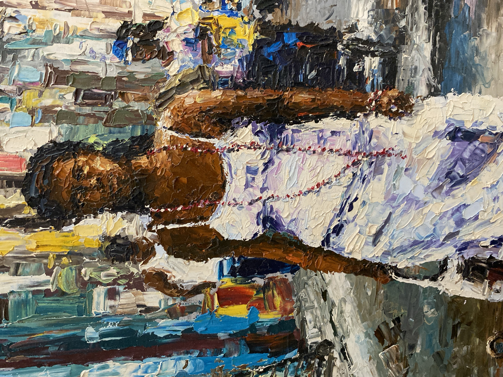 An impressionistic oil painting depicts a street scene with several figures. The central figure is a woman with dark skin and braided hair, wearing a white slip dress with thin straps and a multi-strand necklace of red beads. She carries a white bag in her left hand and stands with her body turned slightly to the viewer's right. Behind her and to her left, another person with dark skin is visible from the chest up, wearing a white tank top. To the right of the central figure, a person with dark skin and a blue head covering is partially visible, wearing a white top. The background is an abstract representation of buildings with a variety of colors and textures, suggesting a busy urban environment. The paint is applied thickly, with visible brushstrokes, creating a textured effect. The lighting appears to be bright, casting shadows and highlighting the figures.