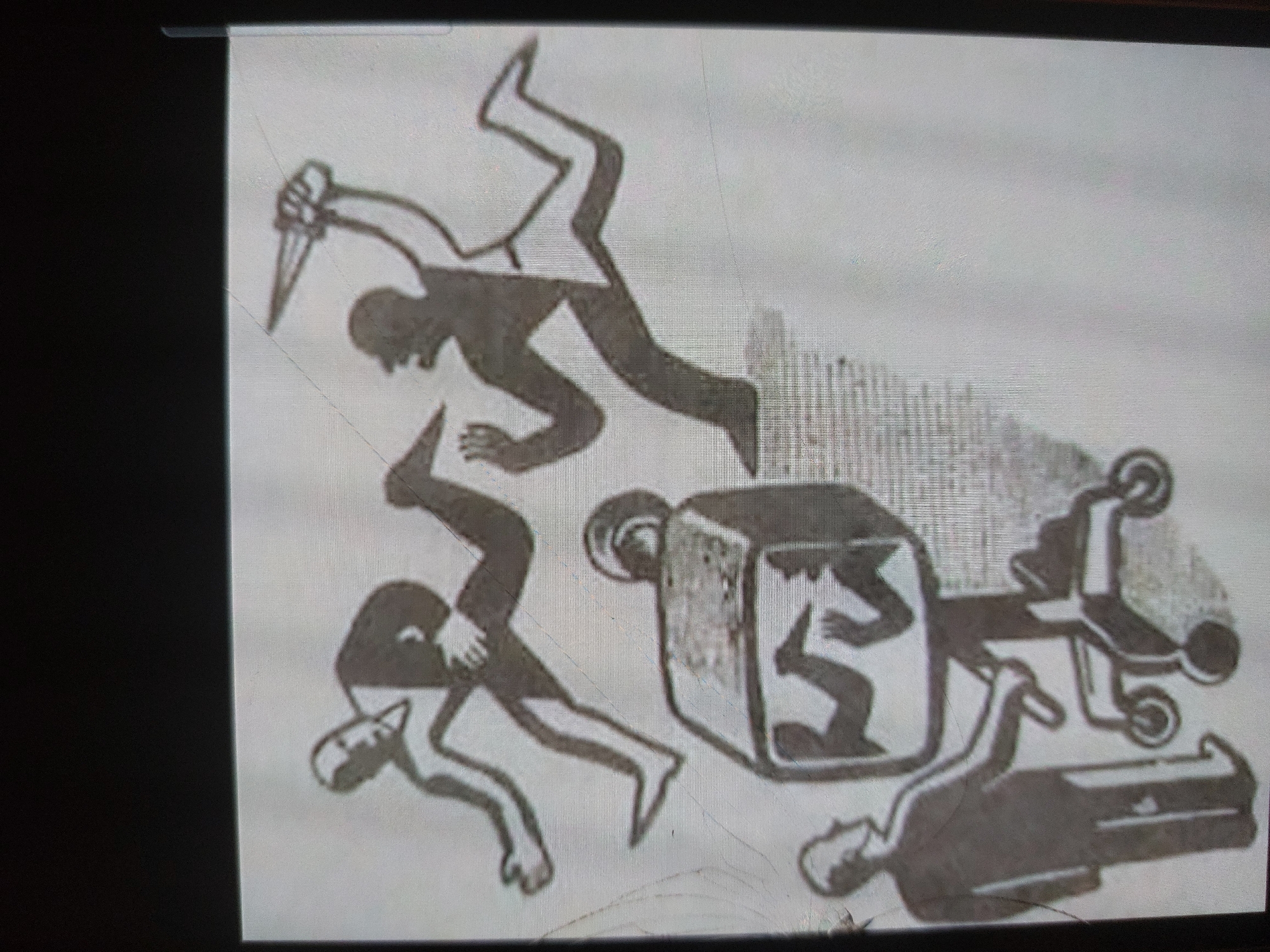 This is a monochromatic, stylized drawing depicting a violent and somber scene, photographed from a screen as evidenced by visible scan lines, glare, and reflections. The artwork features several human figures rendered in dark silhouettes against a light grey background.
In the upper central part of the image, a figure is shown in a dynamic, attacking pose, holding a large, sharp knife or dagger in their raised right hand. This figure appears to be running or lunging. Below the attacker, another figure is depicted in a falling or running motion, seemingly trying to escape or having been struck, with limbs splayed.
To the right, there is a rectangular, box-like structure, possibly a coffin or container, with a human figure crouched or folded inside it. This box is positioned next to a wheeled cart or gurney, suggesting the transport of the box or its contents. Lying on the ground to the lower right is another human figure, appearing still and possibly deceased, rendered in a prone position. A partially obscured figure is also visible on the lower left, potentially falling or attempting to crawl away.
A patterned background element resembling a fence or a series of vertical bars is visible behind the central action, suggesting an enclosed or constrained environment. The drawing’s primitive, almost hieroglyphic style, combined with the subject matter, conveys themes of aggression, death, and confinement. There is no visible text within the drawing itself. The scene is likely a depiction of a murder or violent crime. The context for the image is Tsarevo, Bulgaria.