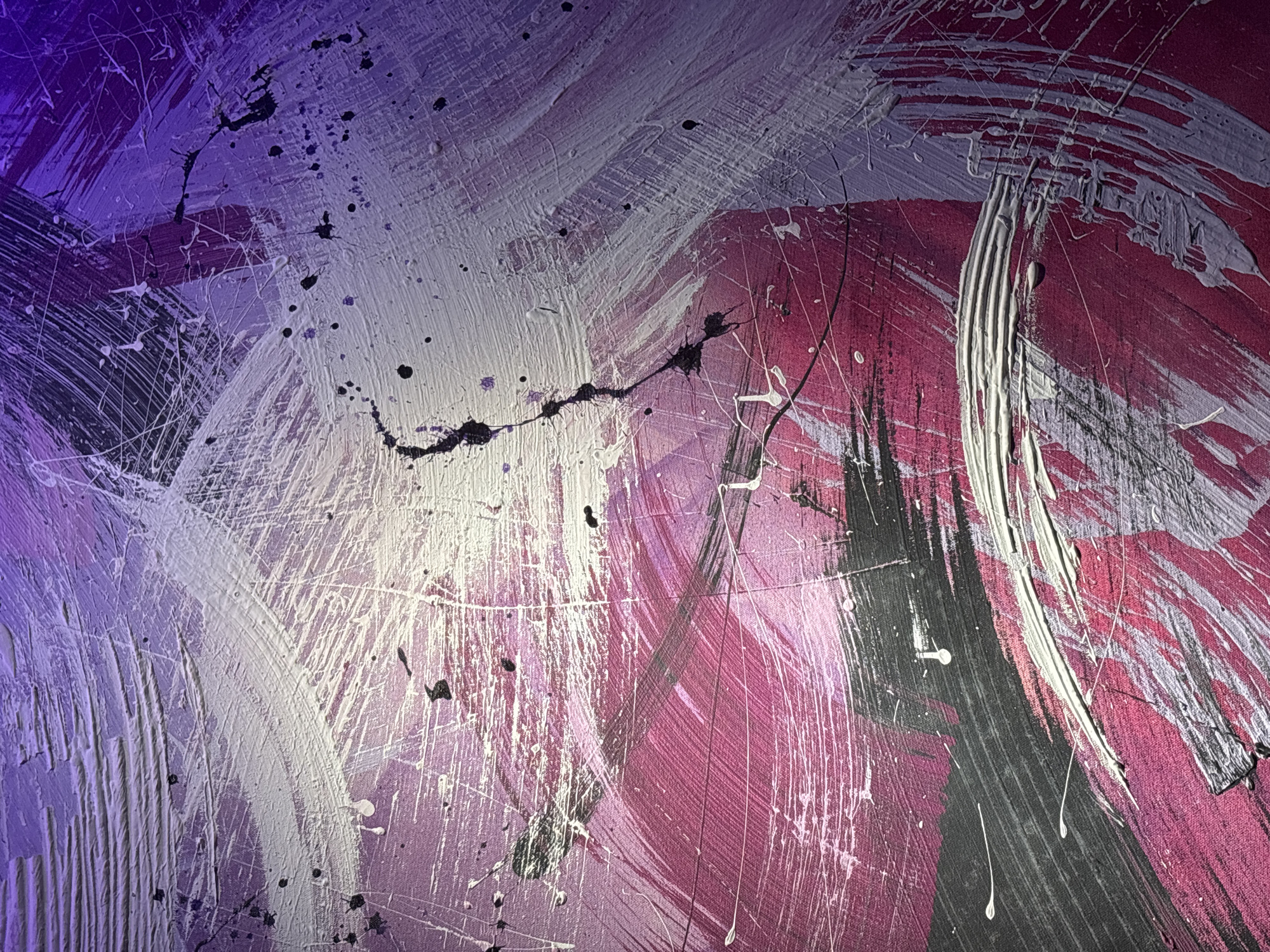 The image shows an abstract painting with bold brushstrokes in purple, white, pink, and black. The paint appears thick and textured, with splatters and drips evident throughout the composition. The brushstrokes are generally curved and directional, creating a sense of movement within the artwork. There is no indication of the location being Kuta Selatan, Indonesia, as there are no identifiable features suggesting a specific location or cultural context.