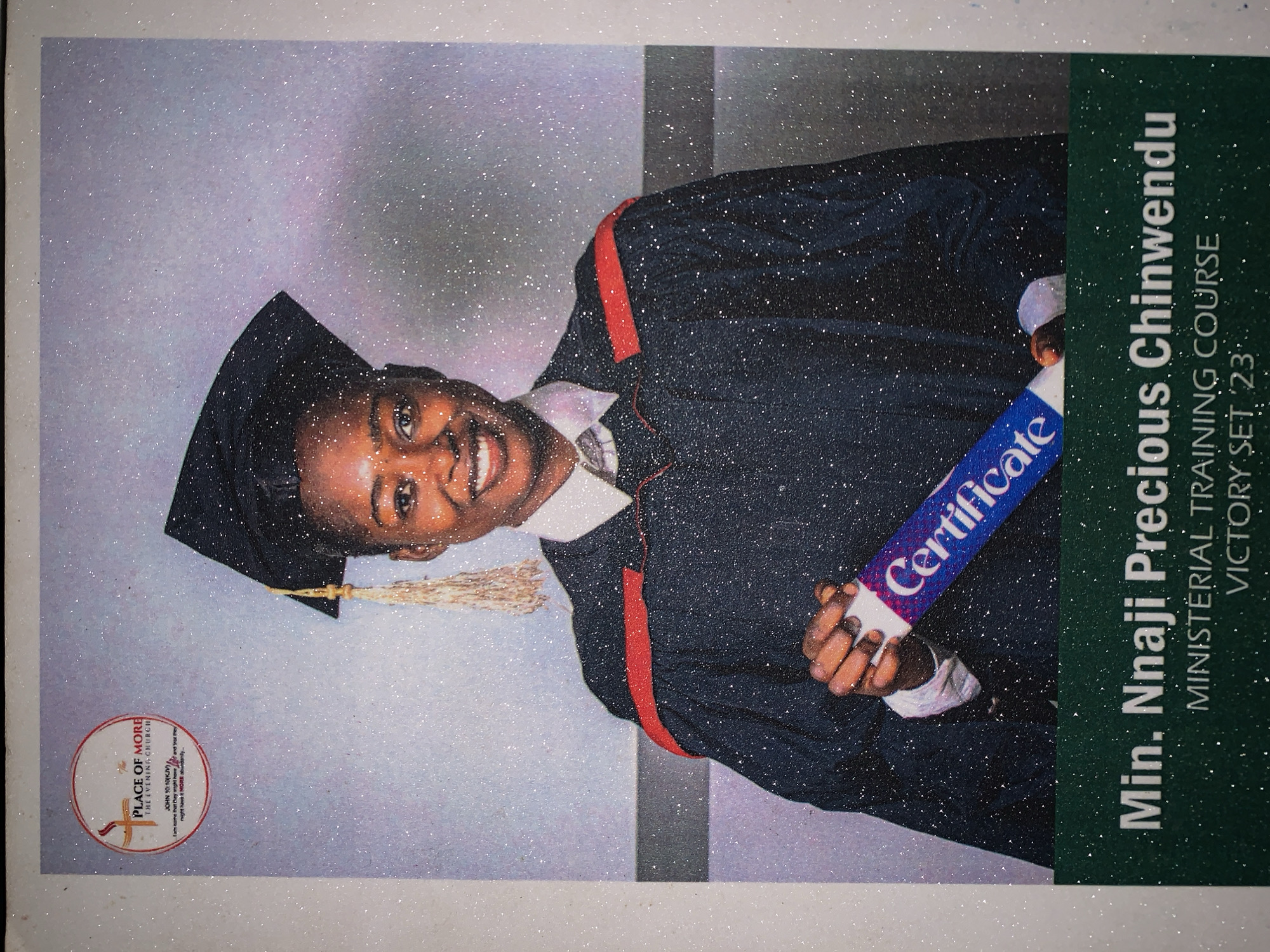Here is a detailed description of the image:
The image is a graduation portrait of a woman named Min. Nnaji Precious Chinwendu, who has completed the Ministerial Training Course, Victory Set '23. She is wearing a graduation cap and gown with a red stripe. She holds a rolled "Certificate" in her hands.
In the lower-left corner is a logo for "PLACE OF MORE THE EVENING CHURCH" along with the bible verse John 10:10 (KJV).
To the right is a green box with white text indicating "Min. Nnaji Precious Chinwendu", "MINISTERIAL TRAINING COURSE", and "VICTORY SET '23'".
The portrait has a glittering effect overall, resembling glitter or sparkle. The background appears to be a light grey. The image is likely from Rafin Par, Nigeria, due to the OCR's extracted reference to the "PLACE OF MORE" church.