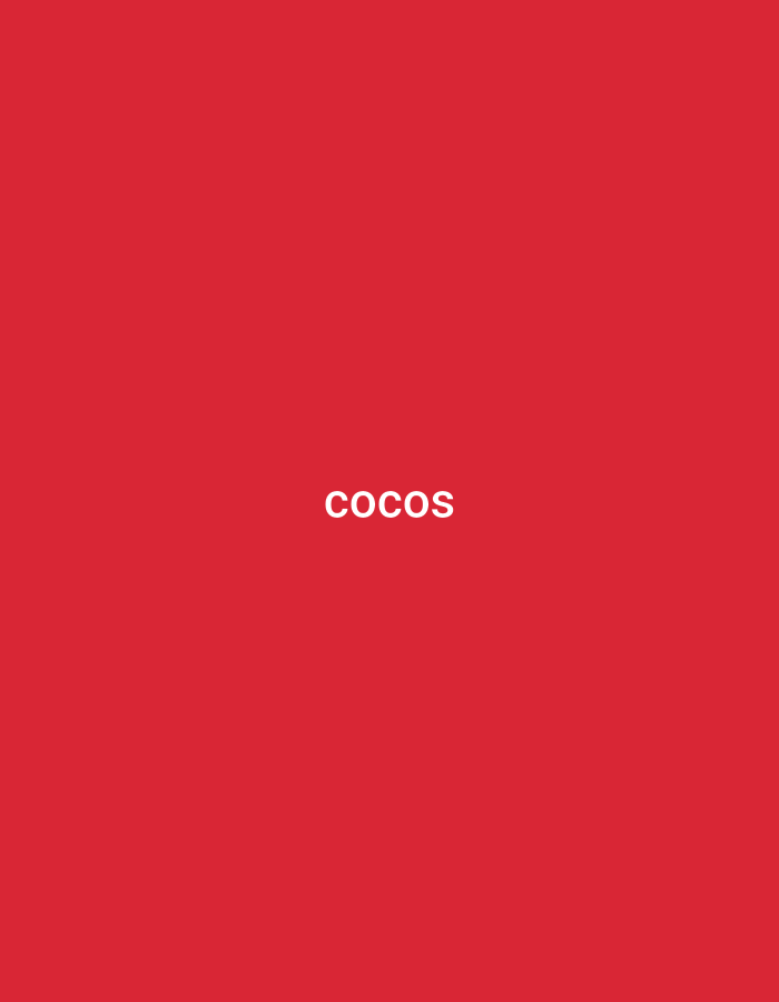The image is a plain red background with the word "COCOS" written in white text in the center. There is no discernible location in the city of Verkhniachka, Ukraine, or any other environmental details.