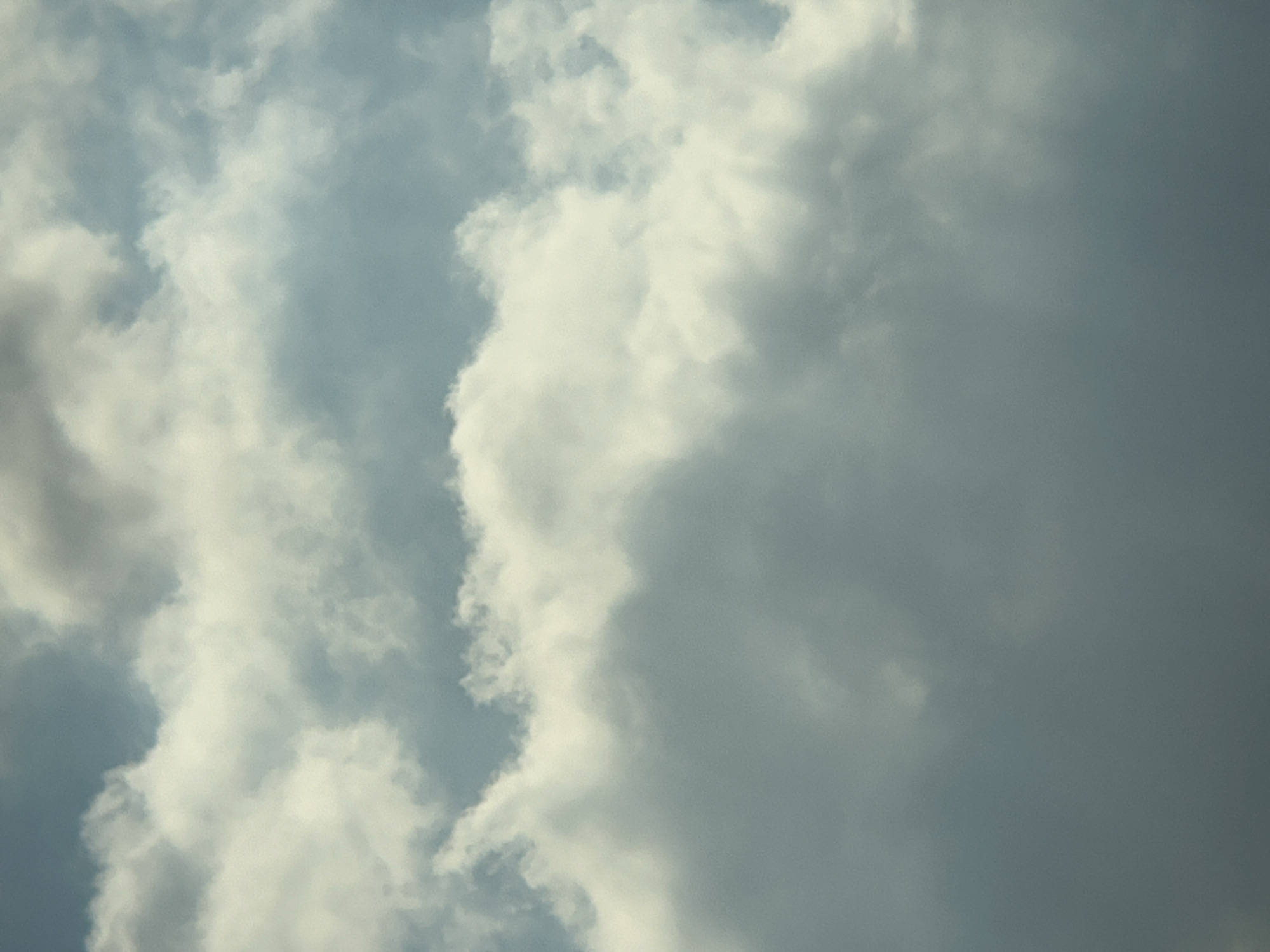 The image depicts a cloudy sky with varying shades of grey and white. There are no discernible landmarks or elements that would place it specifically within the city of Lyubertsy, Russia. The composition is abstract, focusing solely on the atmospheric conditions of the sky. No people, subjects, objects, or actions are visible. The environment is entirely the sky.