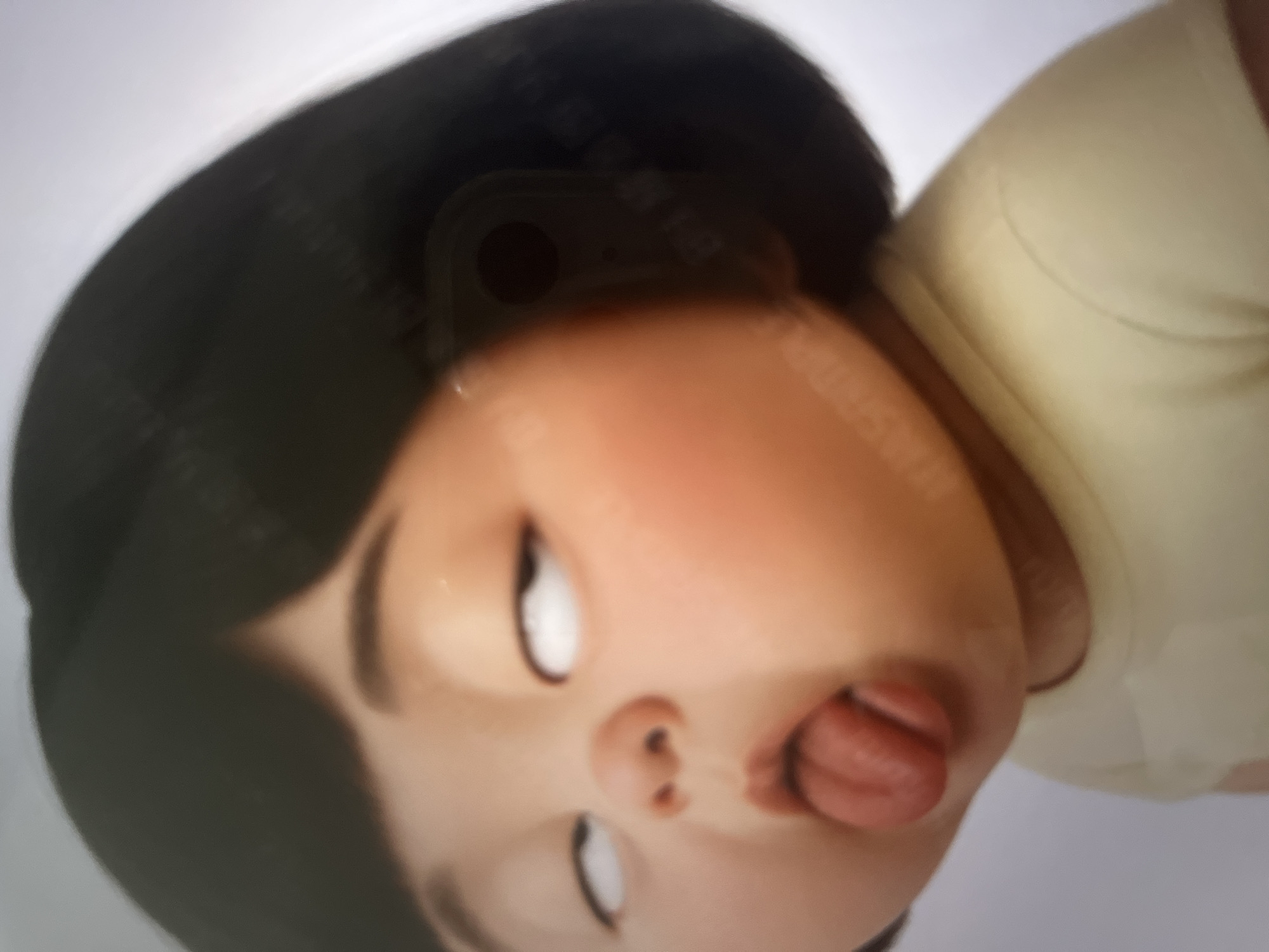 A close-up, waist-up, studio portrait of a cartoon child. The child has black hair, rosy cheeks, and is sticking out their tongue. Their eyes are rolled back, showing only the whites. The child is wearing a light yellow t-shirt. The background is a plain white gradient. The image is an illustration.