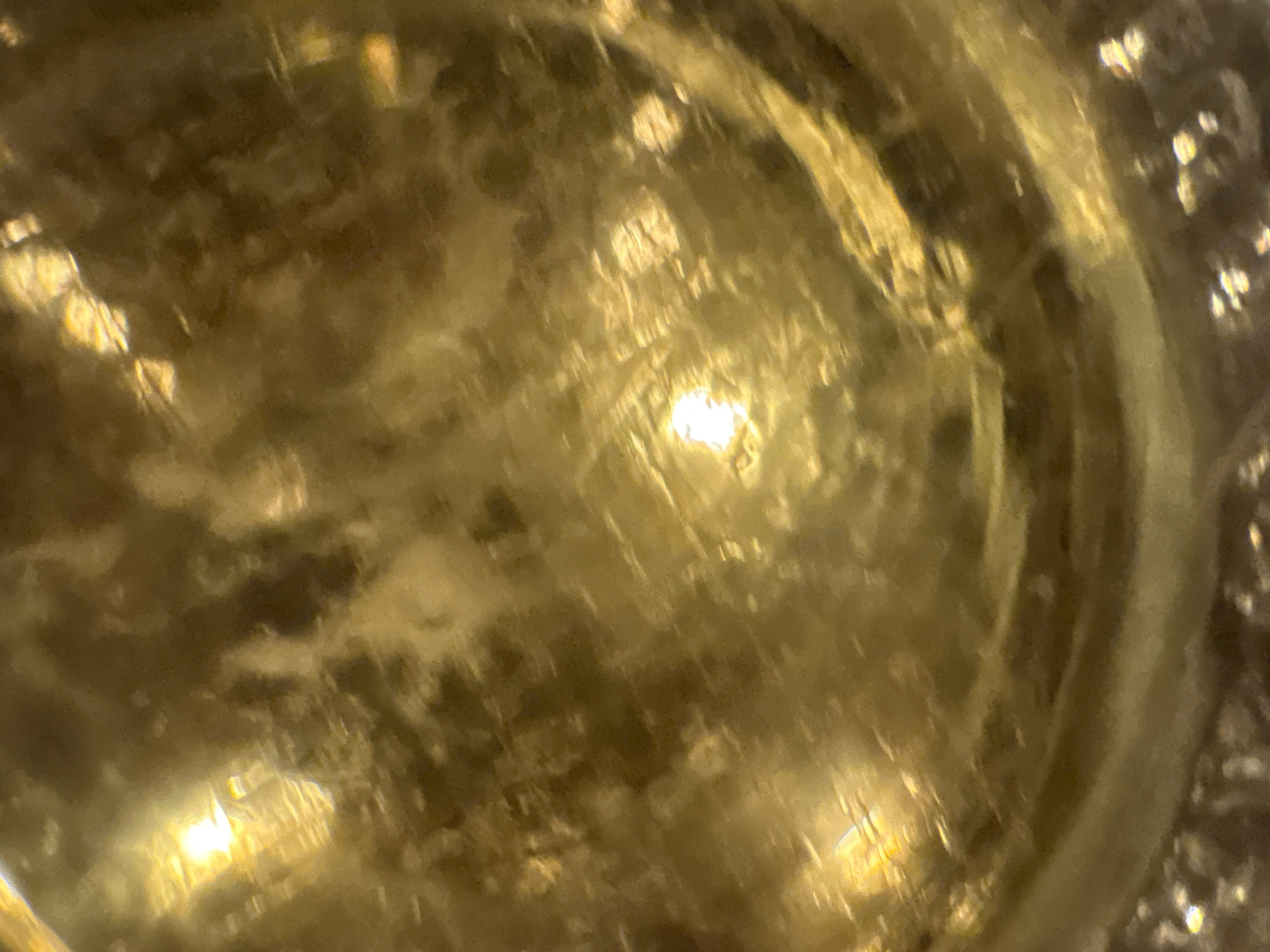 The image shows a close-up view of the interior of a golden, possibly translucent, object. There are light reflections and patterns within the material. The location (Sofia, Bulgaria) is not discernible from the image.