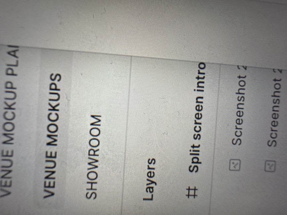 The image presents a high-resolution, slightly blurry, close-up photograph of a digital screen, likely a monitor or tablet display. The screen exhibits a light grey or white background with dark grey to black text. Visible pixel grid patterns confirm it is a digital display.
The content displayed on the screen appears to be part of a file explorer, project management interface, or a similar digital application.
Text elements are vertically stacked and include:
- Partially visible at the top: "VENUE MOCKUP PLAI" (likely "PLAN")
- "VENUE MOCKUPS"
- "SHOWROOM"
- A horizontal line separating sections.
- "Layers"
- A hash symbol (#) followed by "Split screen intro"
- An icon resembling a document or image placeholder, followed by "Screenshot 2"
- Another identical icon followed by "Screenshot 2" (partially visible).
No individuals or objects external to the screen display are visible. The image provides no discernible features to identify a physical location within Tunbridge Wells, United Kingdom. The scene depicts a static view of a digital interface, with no active interactions or movements observable.