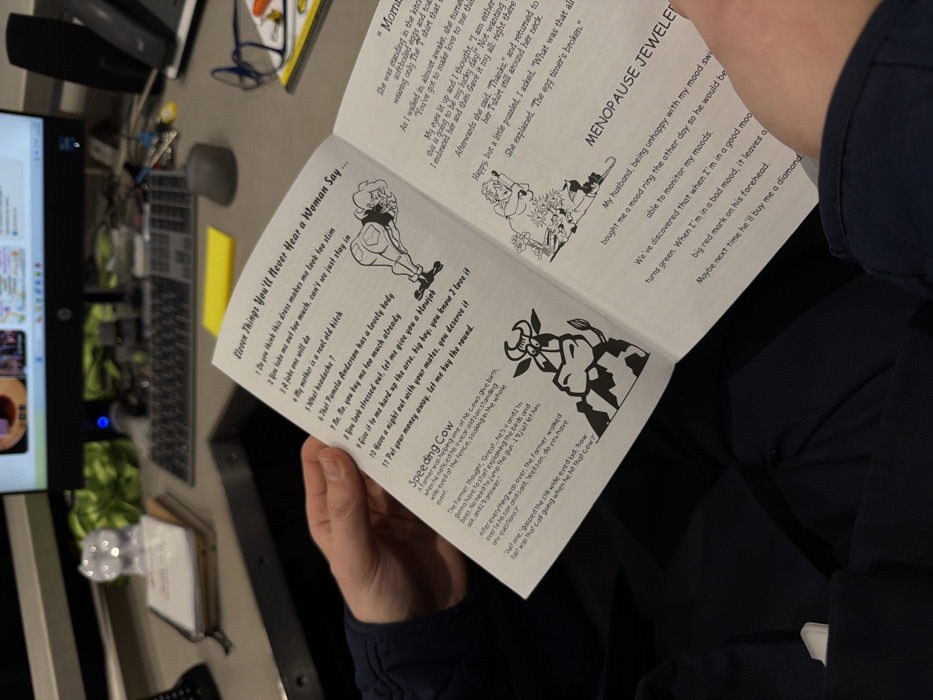 The image shows a humorous pamphlet opened to two pages. One side features a list titled "Eleven Things You'll Never Hear a Woman Say," including phrases like "Do you think this dress makes me look too slim?" and "No, No, you buy me too much already." It's accompanied by cartoon drawings. On the opposite page, there's a section titled "Menopause Jewelry," describing a mood ring and its humorous effects on her husband. Additionally, it contains the joke, "Speeding Cow", a story about a farmer and his son.