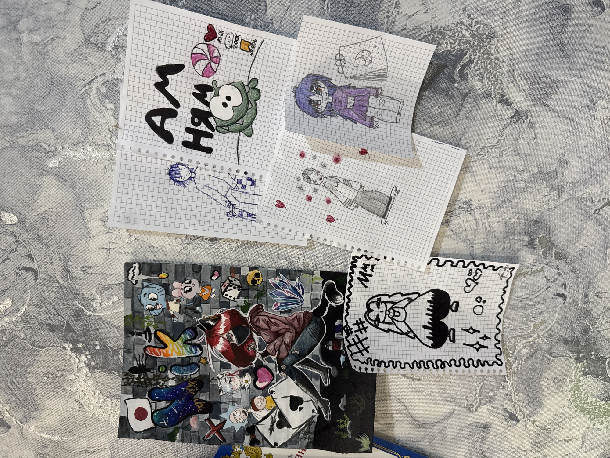 The image shows several pieces of paper with drawings on them scattered on a textured gray surface. The drawings appear to be amateur sketches, depicting various cartoon-like characters and designs. Some are on graph paper.
One drawing reads "I AM нян," and features a green character with a candy and a container. Another depicts a figure with purple hair. There are other drawings that include figures with hearts. A colored drawing shows a collection of cartoon characters and miscellaneous items, including playing cards, a Japanese flag, and a Rick and Morty character. A final drawing is a black and white doodle of a character with space-themed elements.
The location is not discernible from the image. No information suggests this image was taken in the city of Rusanovo, Russia.