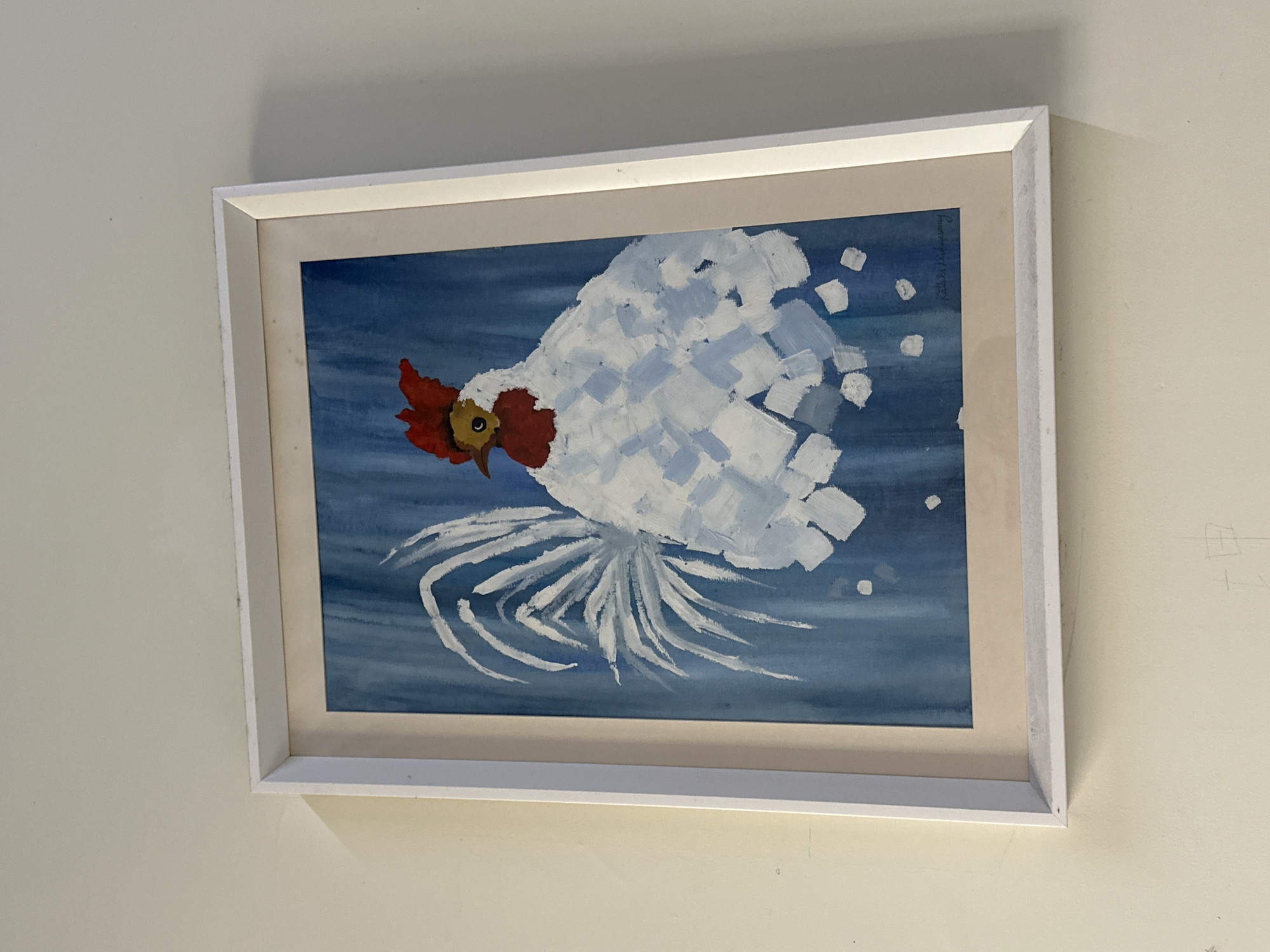 A framed painting of a chicken hangs on a light beige wall. The painting has a blue background with a white chicken depicted. The chicken has a red comb and wattle, and its body is composed of blocky white brushstrokes. It also has a tail with thin white lines. The frame is white. The location, Chongqing High-tech Zone, China, is not evident from the image.