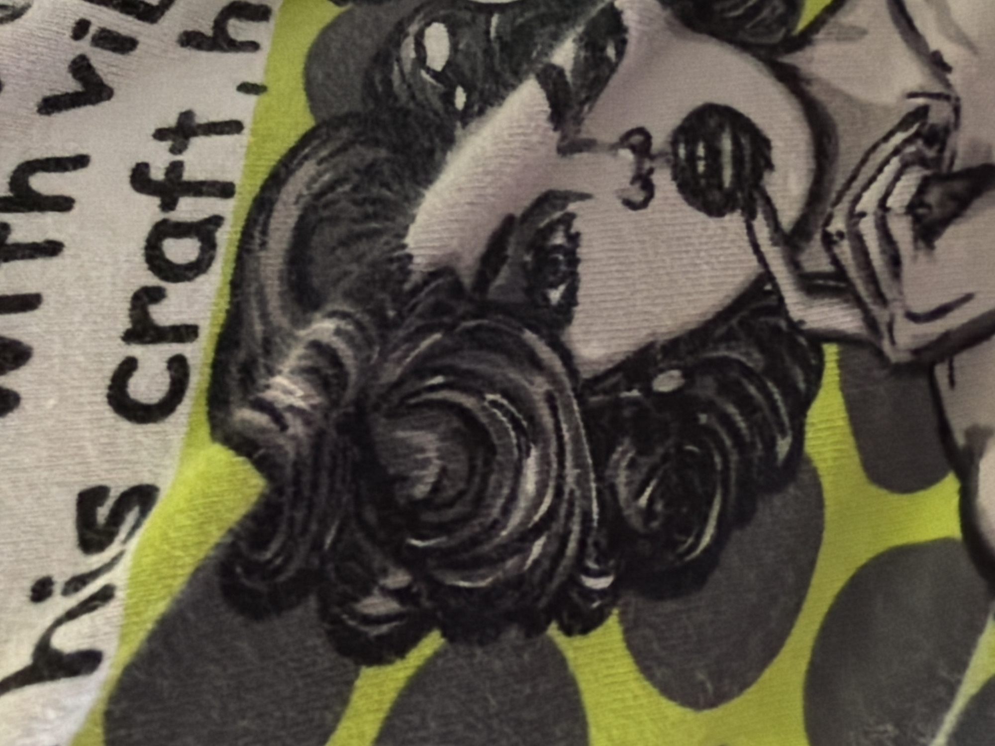 The image shows a close-up of a patterned fabric. The fabric is primarily yellow with large, grey polka dots. A stylized drawing of a woman's face is visible, featuring dark, curly hair and a slightly cartoonish depiction. Text is partially visible on the left side of the image. The phrases "with vib" and "his craft, h" are discernible. The setting and location of the photograph cannot be determined from the given visual information. The city of Perm, Russia is not evident in this image.