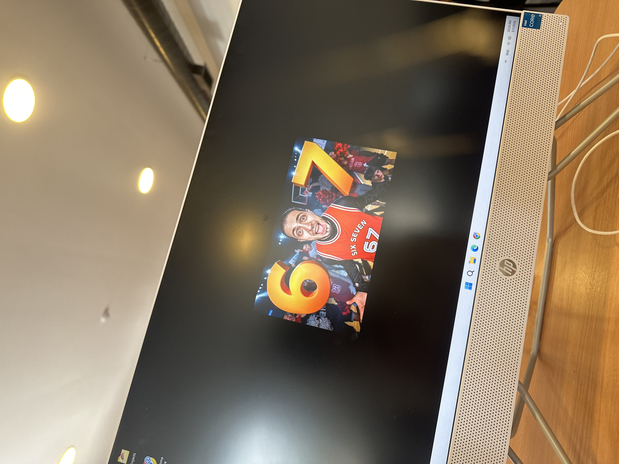A close-up shot of an HP all-in-one computer screen. The wallpaper on the screen features a basketball player, likely Zach Lavine of the Chicago Bulls, with the numbers "6" and "7" overlaid. The right side of the computer shows an Intel Core sticker and the HP logo. The background suggests an indoor setting, possibly an office or a home. The exact location is not identifiable within Yerevan, Armenia based solely on this image.