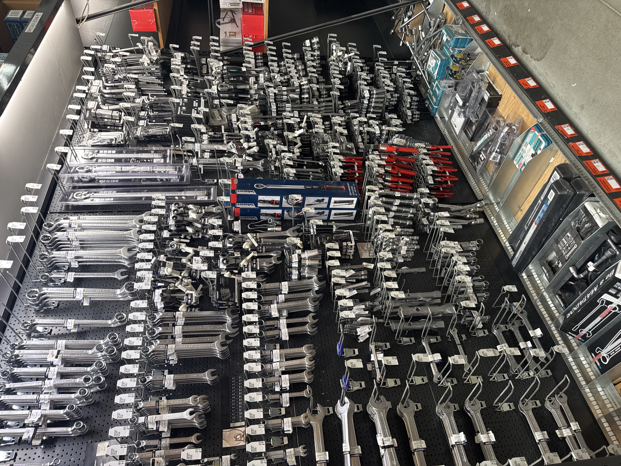 The image shows a display of tools in a store, possibly a hardware or DIY store. The tools, primarily wrenches of various sizes and types, are neatly arranged on a black perforated wall display. Other tools are also on the display, including socket wrenches and sets of Allen keys. Several items have price tags attached. The location appears to be indoors, and the store setting is suggested by the arrangement and display of the merchandise. Some visible text includes brands like "WISENT" and "MATADOR". The background indicates an industrial or commercial setting. Bulgaria and the city of Sofia cannot be determined from the image.