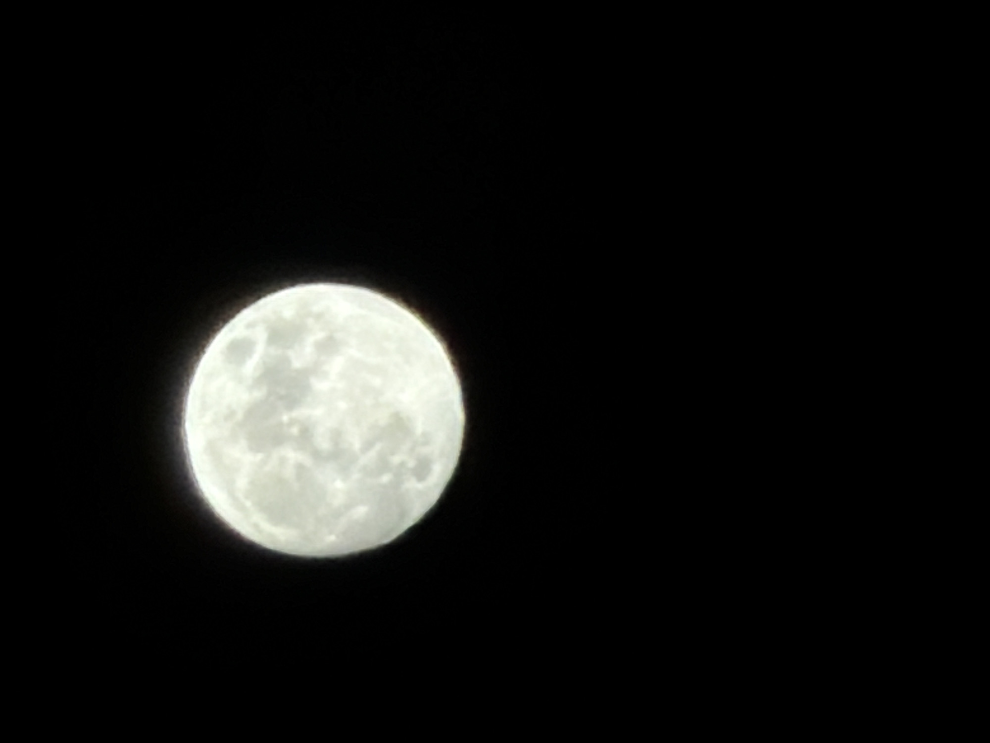 The image shows a full moon against a black night sky. There is no indication of the location being Izhevsk, Russia or any other specific place. There are no people, other objects, or actions depicted in the image beyond the moon itself.