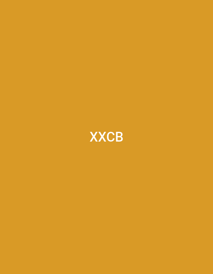 The image displays a solid, uniform mustard yellow background. Centrally positioned on this background are the white uppercase sans-serif letters "XXCB". There are no discernible people, subjects, objects, or actions depicted within the image, nor are there any environmental details. The visual content of the image does not provide any information or contextual clues that would allow for the identification of a specific location within the city of Casablanca, Morocco.