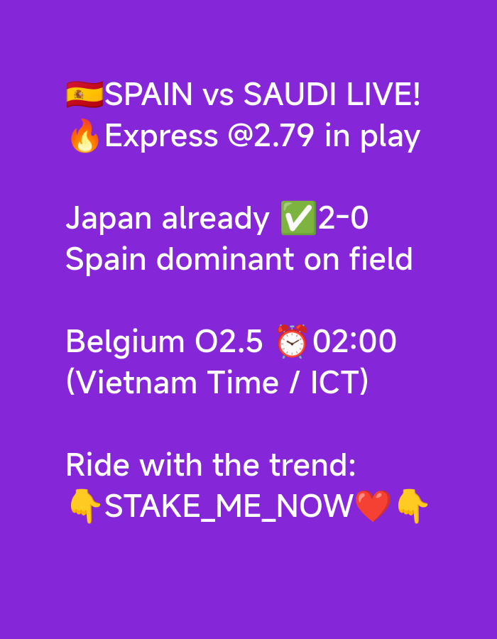 A bright purple background features white text and emojis. At the top, the text "SPAIN vs SAUDI LIVE!" is accompanied by the Spanish flag emoji and a fire emoji next to "Express @2.79 in play". Below this, the text "Japan already 2-0" is shown with a green checkmark emoji. The next line reads "Spain dominant on field". Further down, "Belgium O2.5" is followed by a clock emoji and "02:00". The next line states "(Vietnam Time / ICT)". At the bottom, the text "Ride with the trend:" is followed by a pointing finger emoji, "STAKE_ME_NOW", a red heart emoji, and another pointing finger emoji.