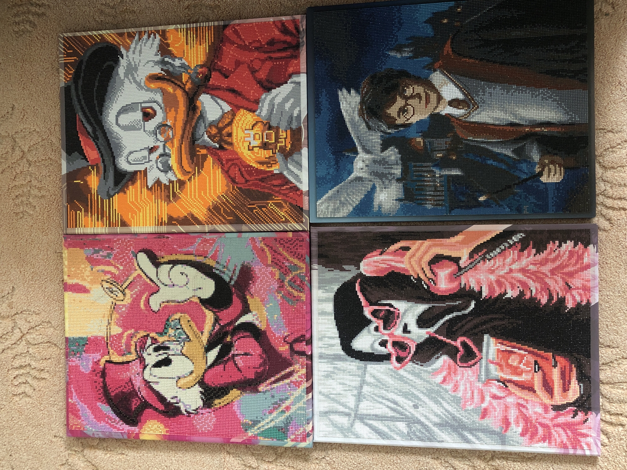 Four diamond painting artworks are displayed on a tan carpet.
Top Left: A depiction of Scrooge McDuck holding a gold coin. The background features an orange circuit board pattern.
Top Right: Harry Potter on his broom holding his wand. Snowy white background.
Bottom Left: Pink and Yellow artwork of Mickey Mouse.
Bottom Right: A painting of an older woman with pink heart glasses.