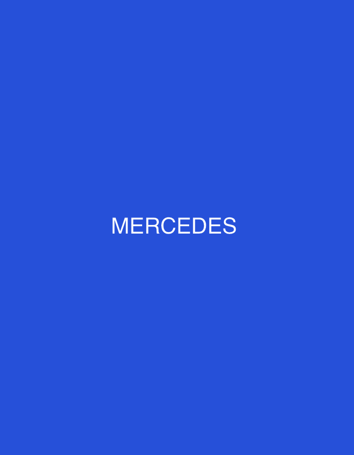 The image is a photograph of a solid blue background with the word "MERCEDES" written in white capital letters in the center. There is no indication of any location within the city of Delmenhorst, Germany. The image contains no people, subjects, objects, actions, or interactions. The environment is entirely the blue background and the text.