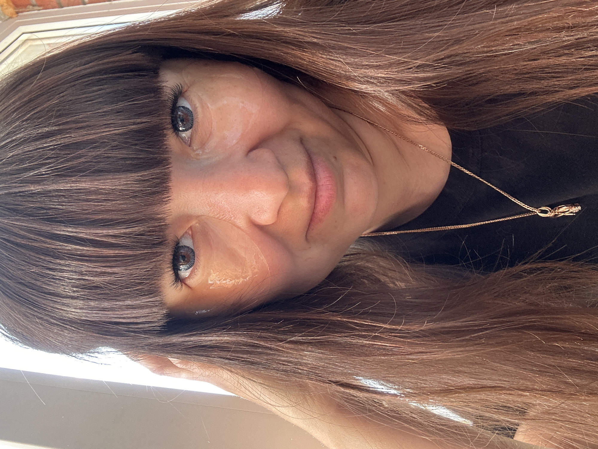 A woman with brown hair and bangs is shown in a close-up portrait. She is wearing a gold necklace and a black shirt. The location is not discernible from the image, and there is no information to suggest it is in Chaikovsky, Russia.