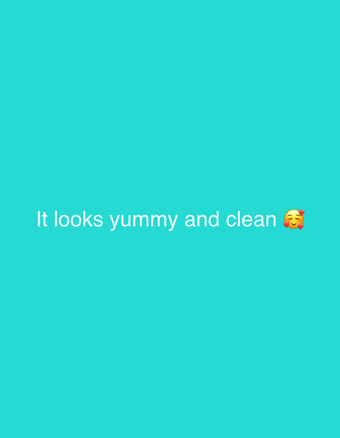 The image is a close-up shot of a bright teal-colored background. In the center of the image, white text reads "It looks yummy and clean" followed by a yellow emoji with rosy cheeks and heart-shaped eyes. There are no people, objects, or environmental elements that would suggest a location in Jalingo, Nigeria, or any other specific geographical area.