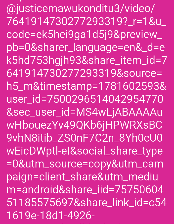 The image displays a close-up of text on a pink background. The text appears to be a URL or a string of parameters with a username, an ID, and various other codes and identifiers. The text is white and predominantly in lowercase, with some uppercase letters and numbers interspersed. The formatting is that of a web address or data string, indicating digital information rather than a physical scene. There are no discernible features of a city, location, people, or actions within the image.