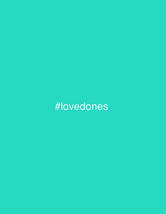 The image is a turquoise background with the hashtag "#lovedones" in white text in the center. There is no visible location, people, subjects, objects, actions, interactions, or any other environmental details.