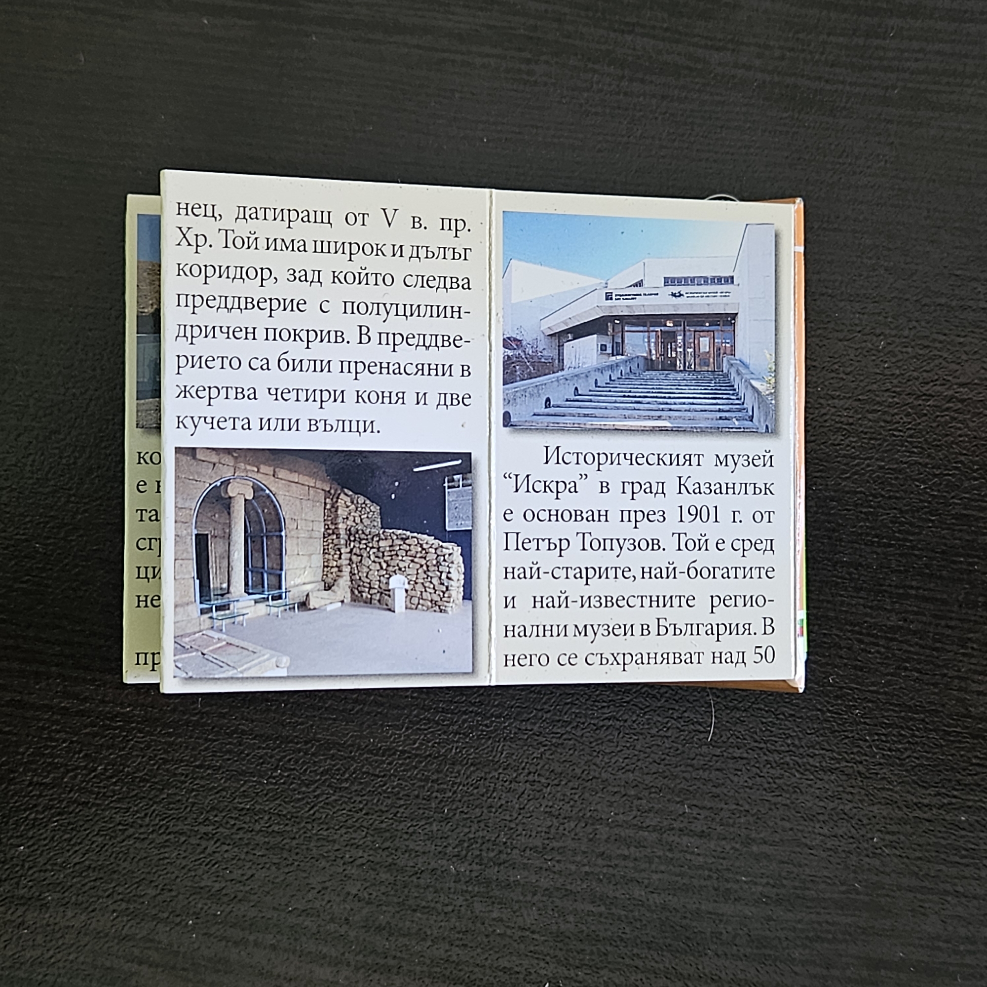 The image shows a close-up view of a set of printed cards or inserts. On the left, text in Bulgarian describes a historical site dating back to the 5th century BC, noting a wide and long corridor followed by an antechamber with a semi-cylindrical roof, where four horses and two dogs or wolves were sacrificed. The right side features two photos. The top photo shows the exterior of a modern building, seemingly a museum or cultural center. The bottom photo shows a stone structure, possibly the interior of a tomb or archaeological site, featuring a column with a capital and a stone wall. Text in Bulgarian next to the photos identifies the Historical Museum "Iskra" in Kazanlak, founded in 1901 by Petar Topuzov, and notes that it is one of the oldest, richest, and most famous regional museums in Bulgaria, housing over 50 original museum items. The city mentioned in the text is Kazanlak, not Stara Zagora.