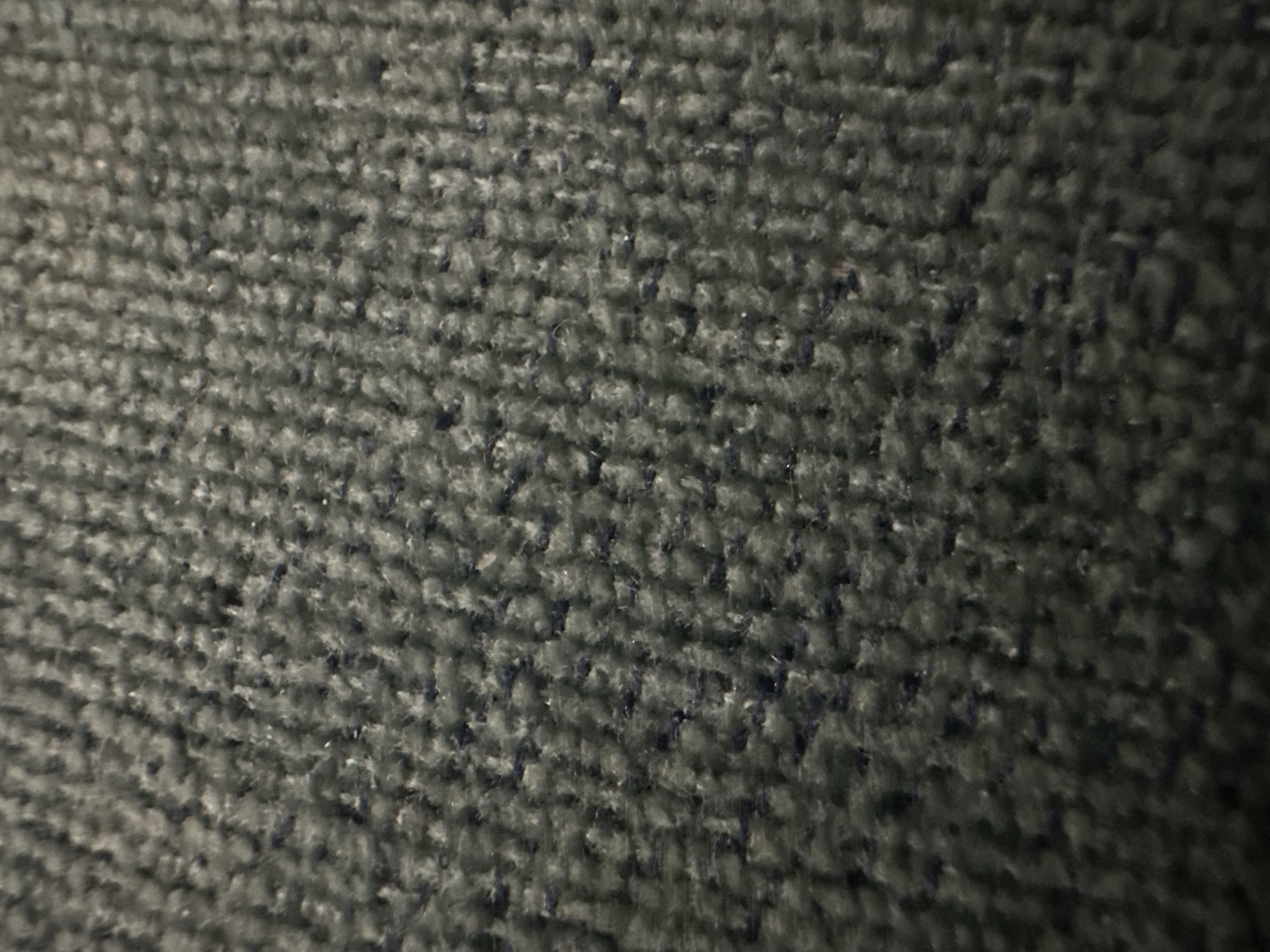 The image shows a close-up of gray carpet. The pile is low and dense, with a slightly textured appearance. There is a subtle variation in the color across the surface. No city or location can be determined from this image.