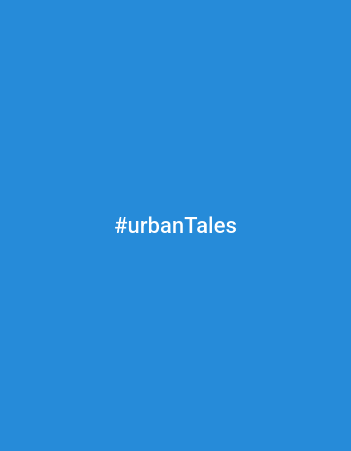 The image shows the text "#urbanTales" in white font against a solid blue background. There is no location in the city of Unknown, Unknown visible. There are no people, subjects, objects, actions, interactions, or environmental details other than the color.