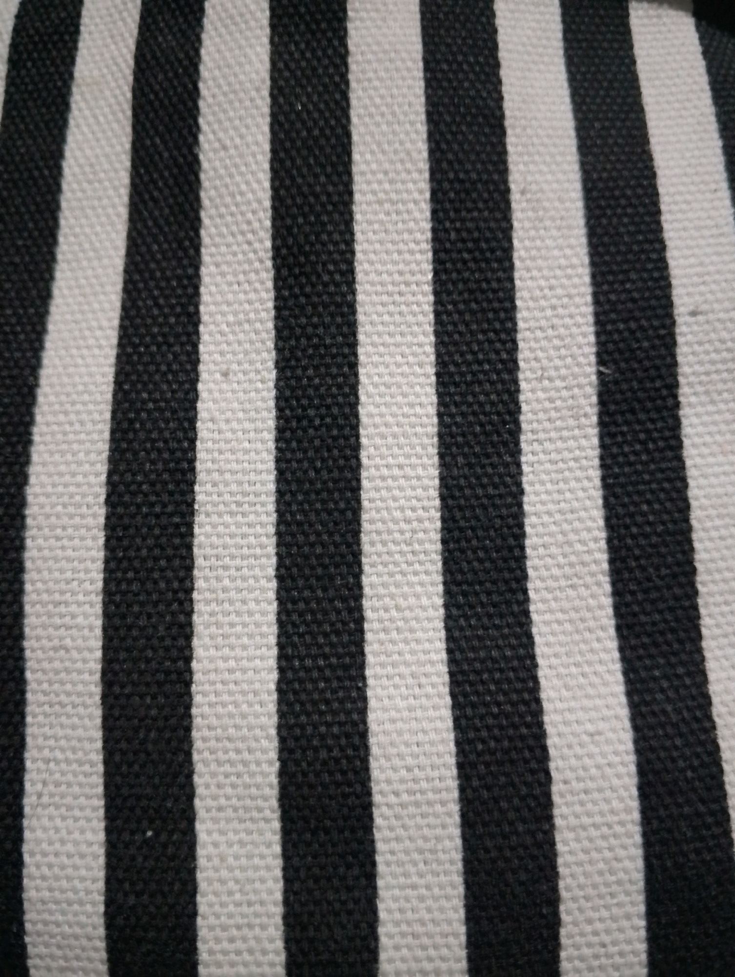The image shows a close-up, abstract view of a black and white striped fabric. The stripes are vertical and appear to be of equal width. The fabric has a visible weave texture. No other objects, people, or environmental details are discernible. The location in Kendalrejo, Indonesia, is not represented in the visual information of this image.