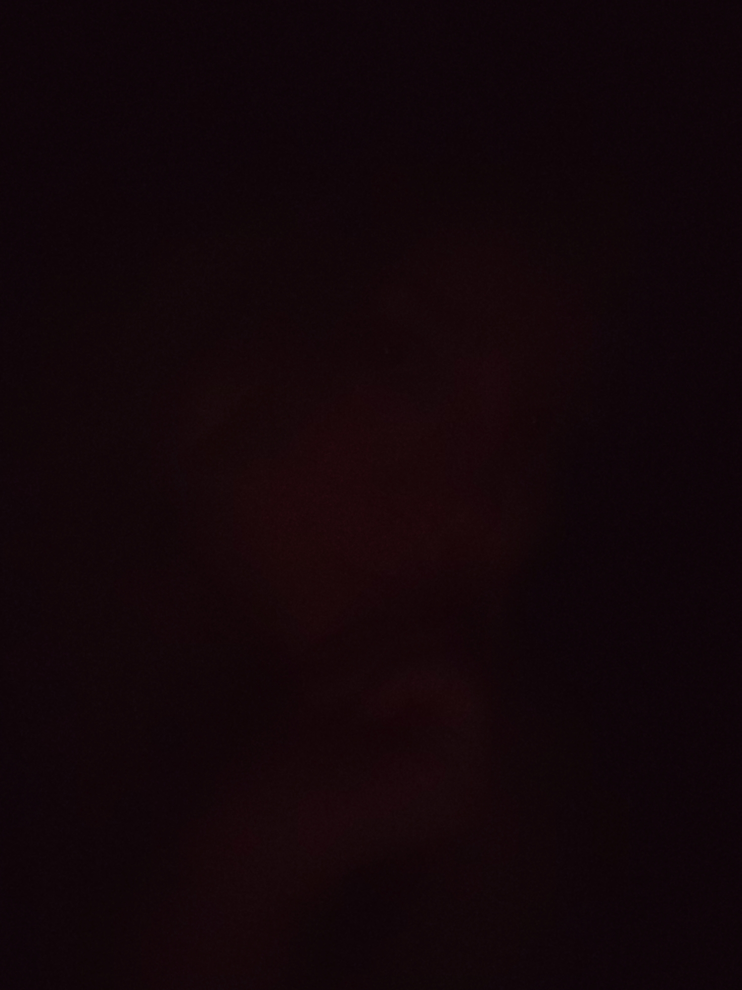 The image is too dark to provide any meaningful description of the scene or its location in Izhevsk, Russia. It's essentially a black or near-black field with no discernible content.