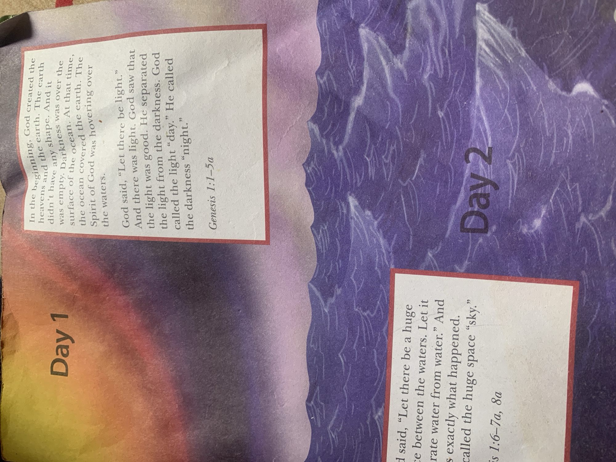 The image shows two pages from a book, likely a children's book, detailing the creation story from Genesis. The left page features the title "Day 1" in large black text against a colorful, abstract background of yellow, orange, and purple. To the right of "Day 1", a block of text describes the creation of the heavens and the earth, the darkness, and the separation of light from darkness, concluding with "Genesis 1:1-5a".
The bottom part of the image shows the "Day 2" section. "Day 2" is written in large black text on a purple background depicting stylized ocean waves. To the left of "Day 2", another block of text describes God creating a "huge space between the waters" and calling it "sky", referencing "Genesis 1:6-7a, 8a".
The image does not contain any information or visual elements that would allow for the identification of a specific location within the city of Jauro Yinu, Nigeria. Therefore, any description of the scene must exclude this detail.