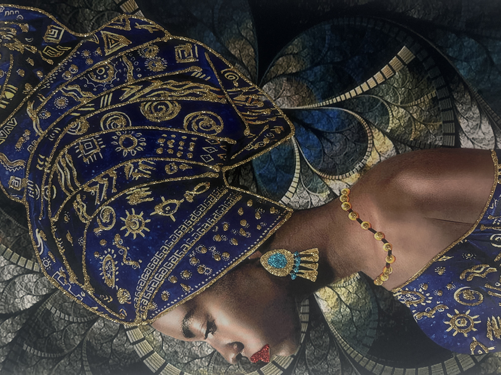 This media file presents a vibrant, stylized portrait of a woman, seen in a side profile. Her head is tilted slightly downwards, and her eyes appear closed or cast down, conveying a serene or contemplative expression.
The most prominent feature is an elaborate, deep blue headwrap, adorned with intricate patterns in gold glitter. These designs include swirls, geometric shapes, sun-like motifs, and wave patterns, lending a luxurious and textured quality to the fabric. One band on the headwrap features repeated stylized symbols, resembling the sequence "GAGA."
The woman wears a distinctive gold earring with a central blue element and smaller dangling gold pieces. Around her neck is a simple gold necklace strung with small, round yellow beads or discs. Her lips are highlighted with striking, glittery red lipstick, adding a vibrant contrast to her complexion and attire.
The background is an abstract, fractal-like design, rendered in muted tones of blue, green, and gold/brown. This complex pattern provides a rich, artistic backdrop that complements the subject's ornate headwear and jewelry without distracting from her presence. The overall aesthetic suggests an artistic composition, possibly a painting or digitally enhanced photograph, emphasizing elegance and cultural embellishment. No explicit text is visible beyond the decorative symbols on the headwrap.