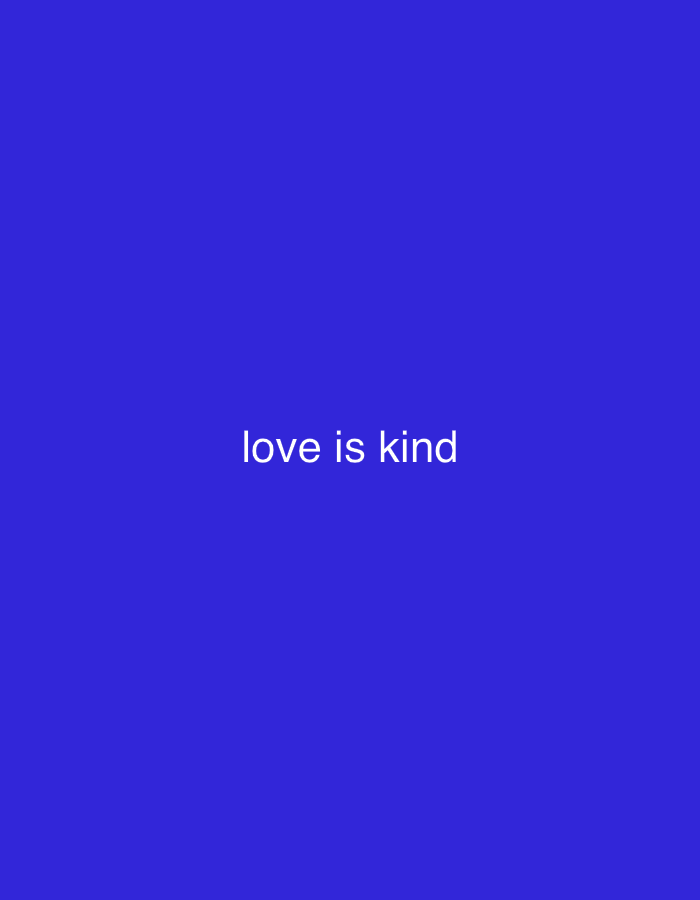The image is a plain blue background with the text "love is kind" in white, centered horizontally and positioned in the lower half of the frame. There are no people, objects, actions, or interactions visible in the image. The location in Jauro Yinu, Nigeria is not relevant to the visual content of the image.