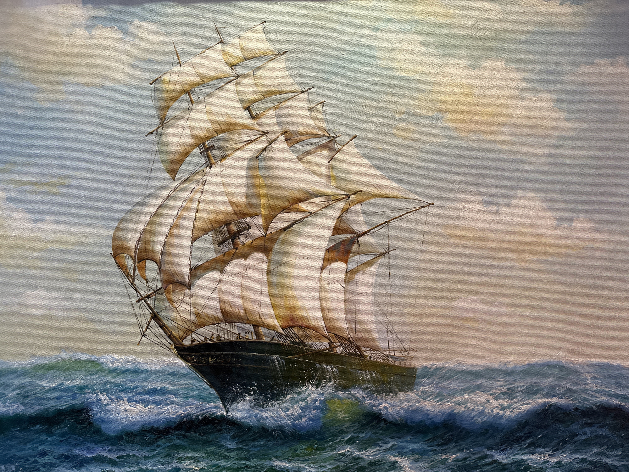This is a painting of a grand sailing ship with multiple masts and sails fully unfurled, navigating through rough, choppy seas under a cloudy sky. The ship is depicted from its port side, with its hull a dark, rich color, cutting through the turbulent blue-green water. Waves crash against the bow, creating white foam and spray. The sails, rendered in shades of white and golden-yellow, are billowing in the wind, suggesting the ship is moving at a good speed. The sky is a mix of light blue with patches of pale yellow and white clouds, hinting at either dawn or dusk, or perhaps a break in stormy weather. The overall impression is one of power, movement, and the grandeur of maritime travel. There are no visible people or text in the painting. The scene captures the drama and beauty of a ship at sea.