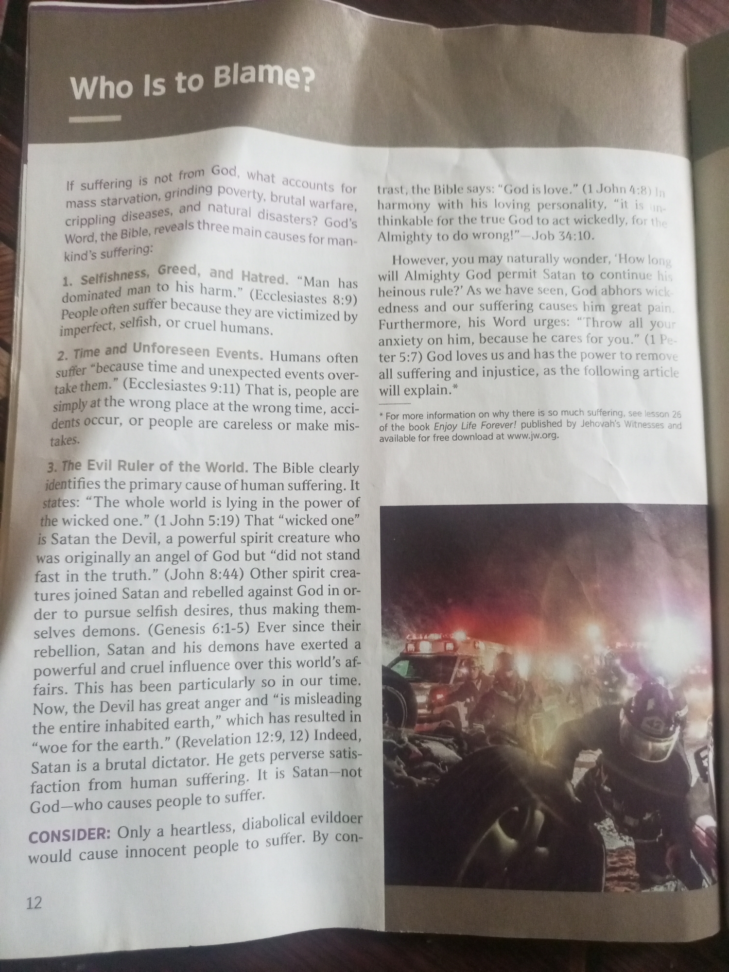 The image is a photograph of a page from a book or magazine. The page has text printed on it, with a heading "Who Is to Blame?" The text discusses causes of human suffering according to biblical interpretation. There is also a photograph at the bottom of the page. The photograph appears to depict a chaotic scene with emergency vehicles, possibly police cars and an ambulance, with flashing lights. There are several figures in the foreground, some of whom appear to be wearing helmets and uniforms, suggesting they might be first responders. The ground is rough and appears to be covered in debris, indicating a possible disaster or accident. The lighting is dramatic, with bright flashes from the vehicles contrasting with the darker surroundings, creating a sense of urgency and disorder.
There is no information in the image to suggest that it is located in Jalingo, Nigeria.