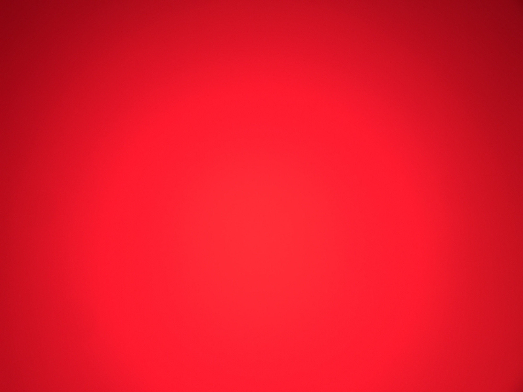 The image is a solid red color gradient. There are no discernible objects, people, or environments depicted in the image to identify any location.