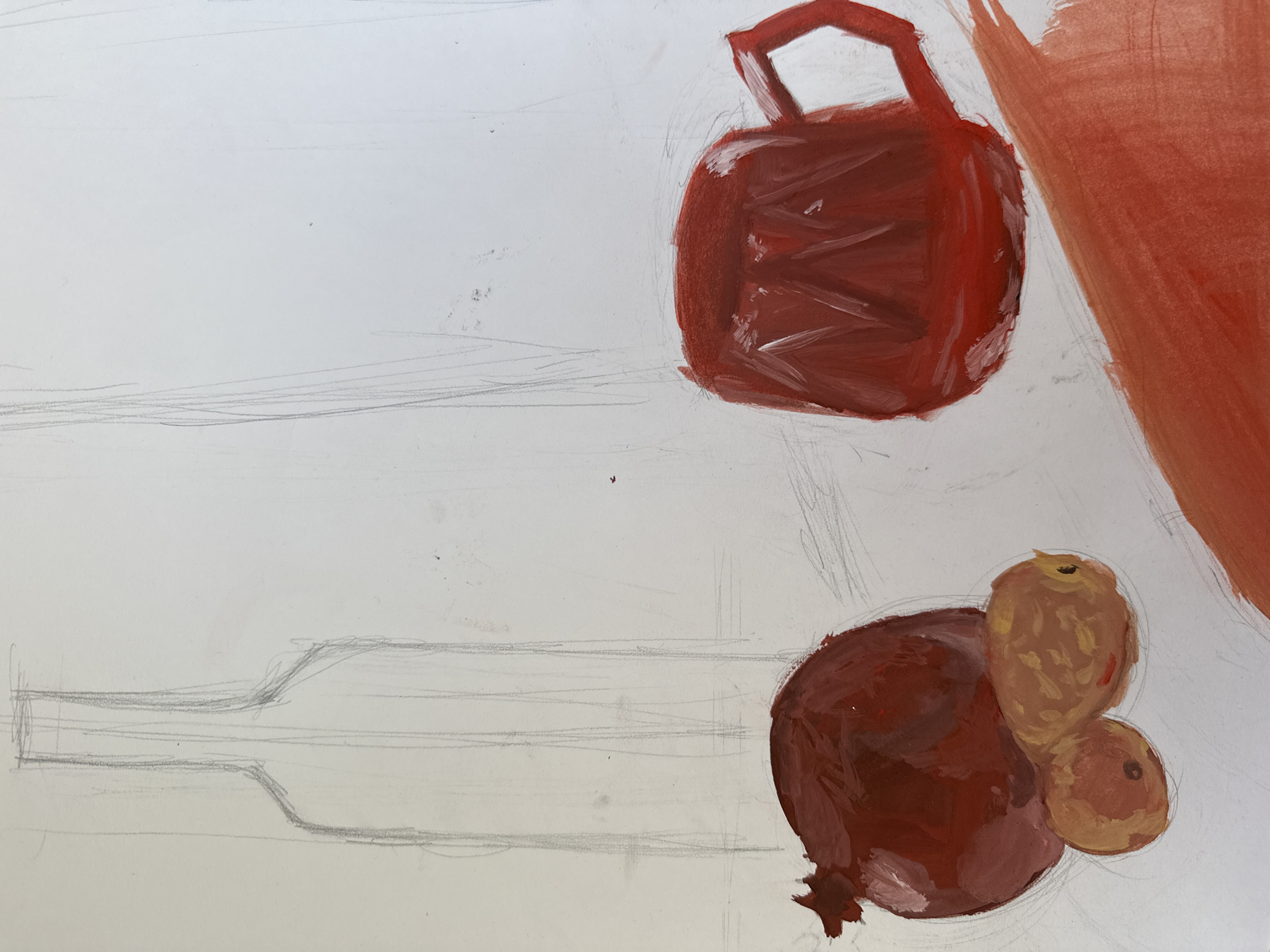 This is a close-up, overhead shot of a still life painting in progress. The artwork features a pomegranate and two smaller fruits on the left, and a red mug on the right. The background is a plain white surface. The subjects are rendered in bold strokes of red and brown paint, with visible brushwork. Preliminary pencil sketches of a bottle and vertical lines are visible in the background, suggesting the composition is still being established. There are no people, actions, or interactions depicted. The setting is not identifiable as being in Almaty, Kazakhstan, or any other specific city.