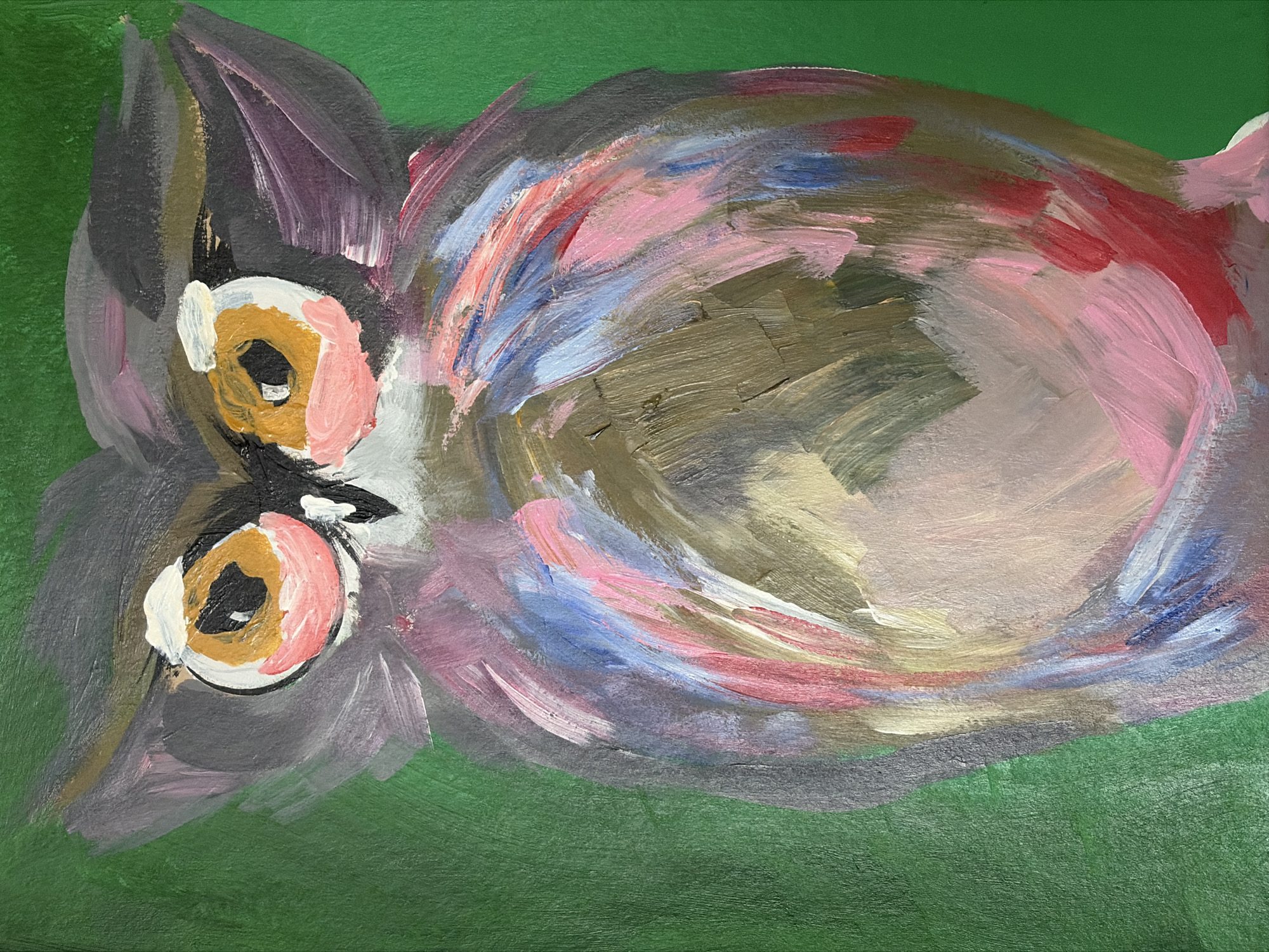 This is a close-up, vertical, eye-level painting of an owl against a solid green background. The owl is rendered in an impressionistic style with visible brushstrokes. Its face is prominent, featuring large, round eyes with yellow and orange irises and black pupils. There are pink and white highlights around the eyes, and the owl's head is primarily gray with some purple and dark gray feathers. The owl's body is depicted with a blend of colors, including pink, blue, white, yellow, and shades of gray and brown, suggesting feathers in a loose, expressive manner. The green background is textured, indicating the canvas or surface the painting is on. The image does not contain any information about a specific city or location.