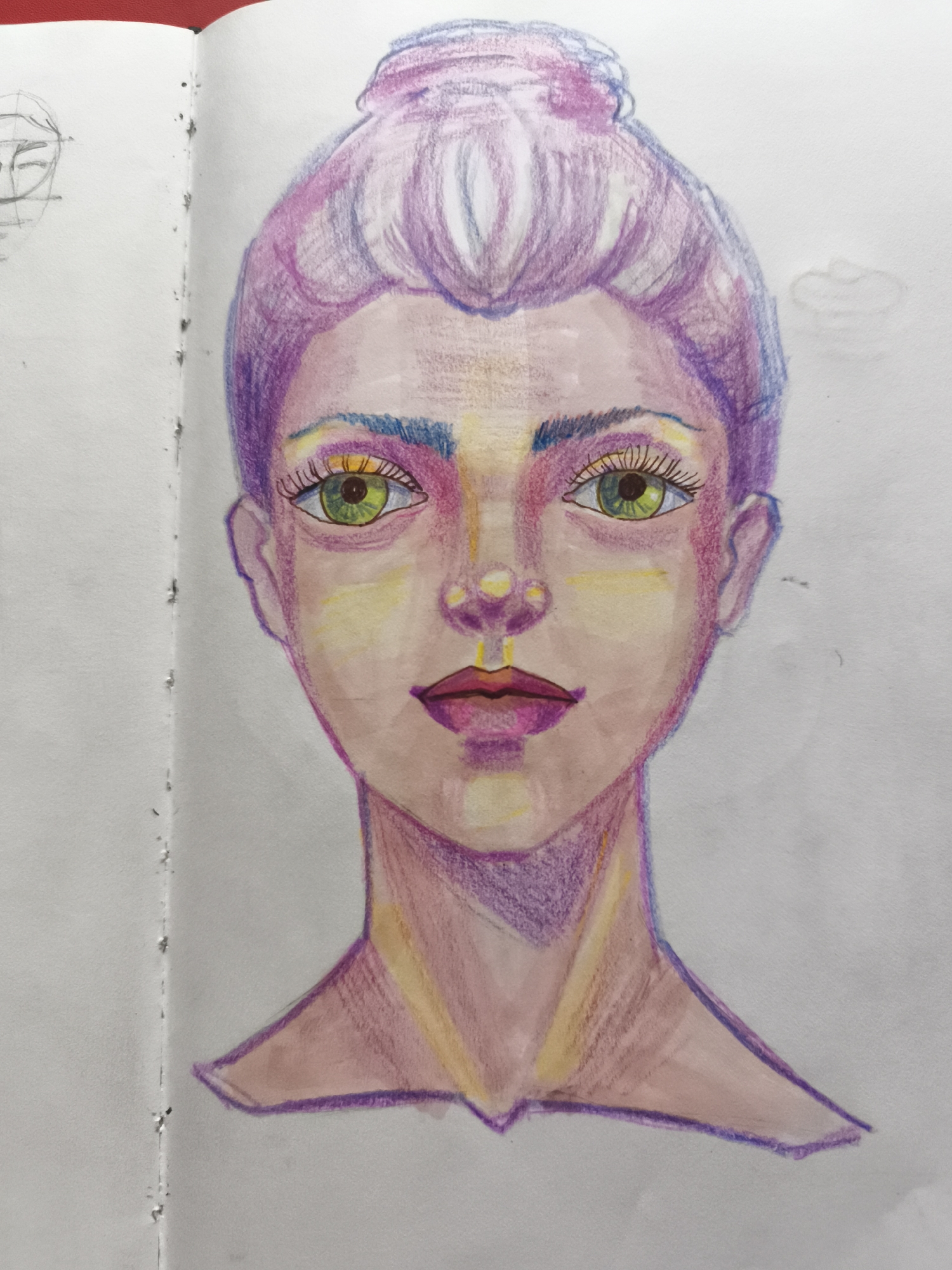 A colored pencil drawing of a woman's face is shown against a white background. The woman has purple hair styled in a bun, green eyes, and is wearing makeup. The drawing is on the right side of an open notebook, with a faint sketch of a face visible on the left page. The notebook pages are bound together by metal rings.