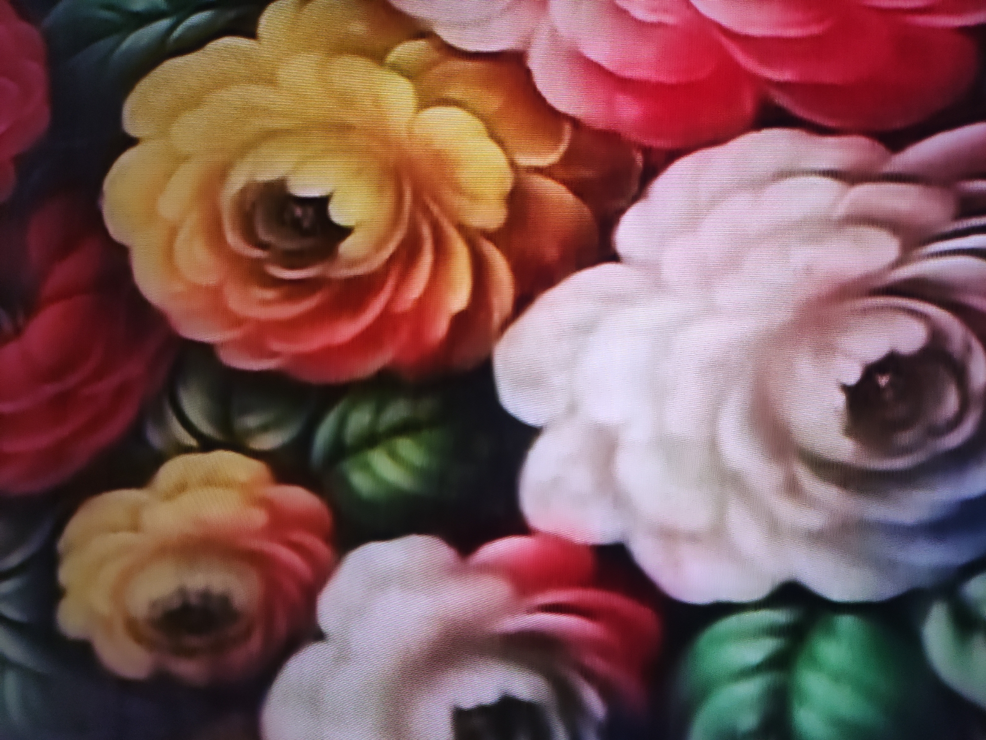 The image shows a close-up view of several flowers in bloom. The flowers are various shades of red, pink, white, and yellow. There are also some green leaves visible in the background. The flowers appear to be densely packed together. There is no information available to indicate that the location of the image is Pavlodar, Kazakhstan.