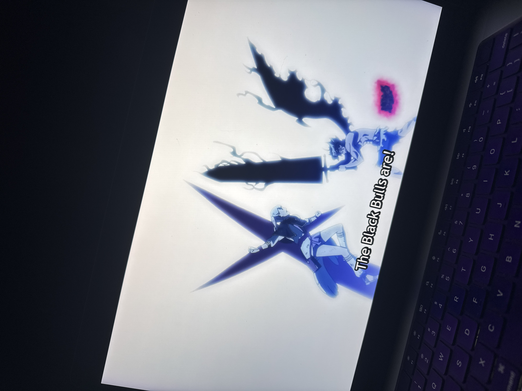 The image shows a laptop screen displaying a scene from an anime, possibly "Black Clover," featuring characters with magical abilities, including a large sword and text that says, "The Black Bulls are!". The laptop is positioned at an angle, with a portion of the keyboard visible. The background surrounding the laptop is dark. The image does not provide any information about the location or any connection to the city of Sofia, Bulgaria.